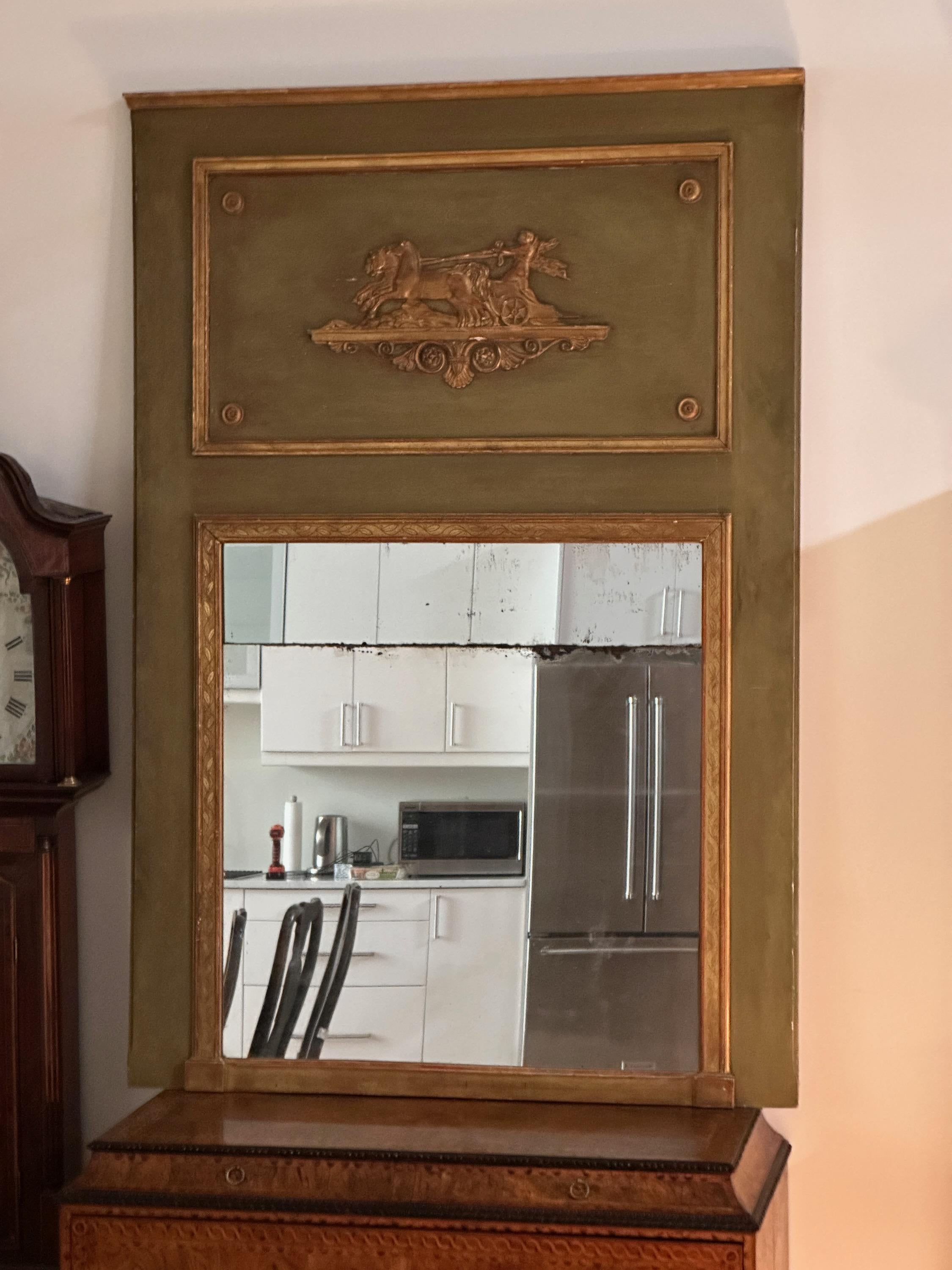A large and impressive mid-19th C. French moss-green painted and gilt decorated trumeau mirror with carved classical motif and original looking glass.
