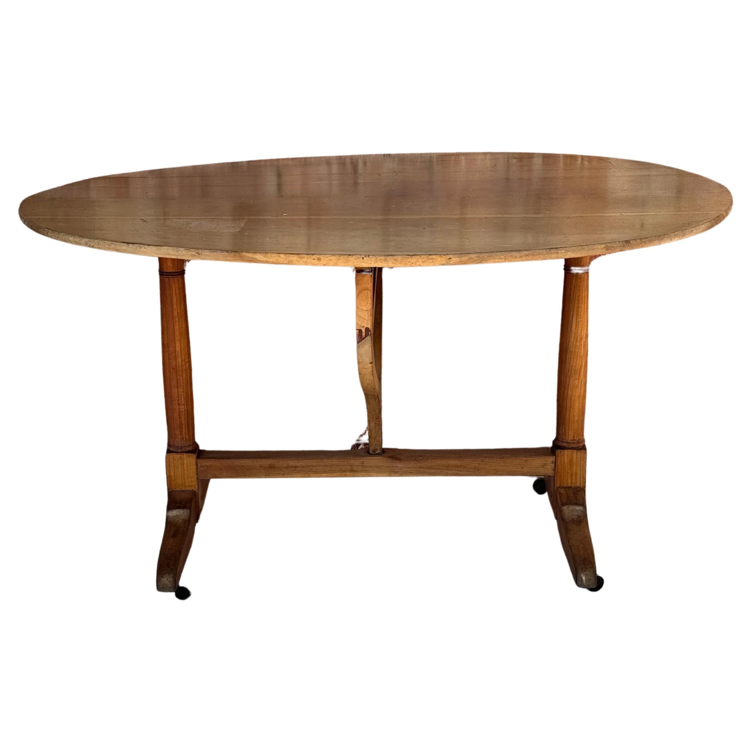 Large 19th century Tilt-top French wine tasting table. The top can be positioned vertically for storage and opened for use as a side or dining table.
Dimensions when tilted up:
49