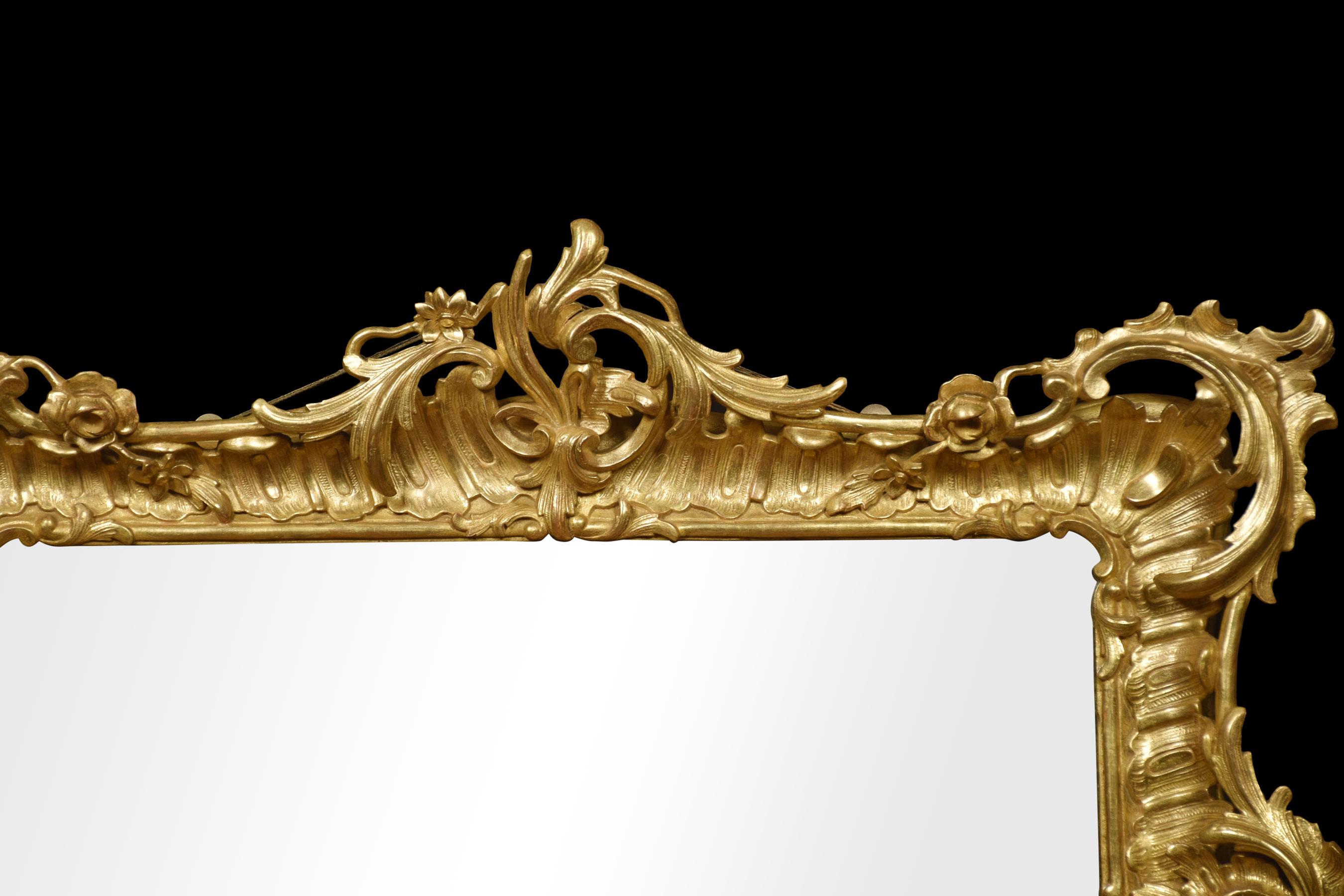 Large 19th-century gilt-wood wall mirror in the rococo manner the scrolling foliated frame surrounding the original mirror plate.
Dimensions
Height 39.5 inches
Width 46.5 inches
Depth 5 inches.