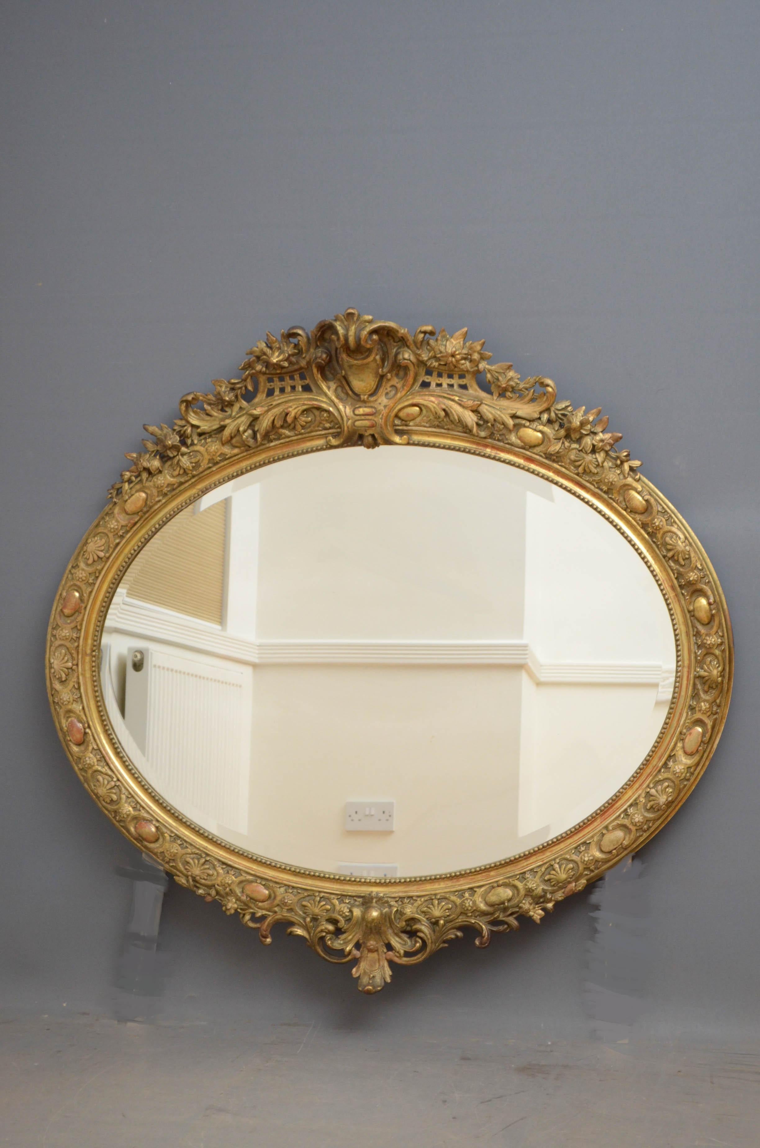 Sn4761, large Victorian period oval wall mirror, having original bevelled edge glass with some foxing in finely carved frame with centre crest to top and base, all in excellent home ready condition, circa 1880
Measures: H 50