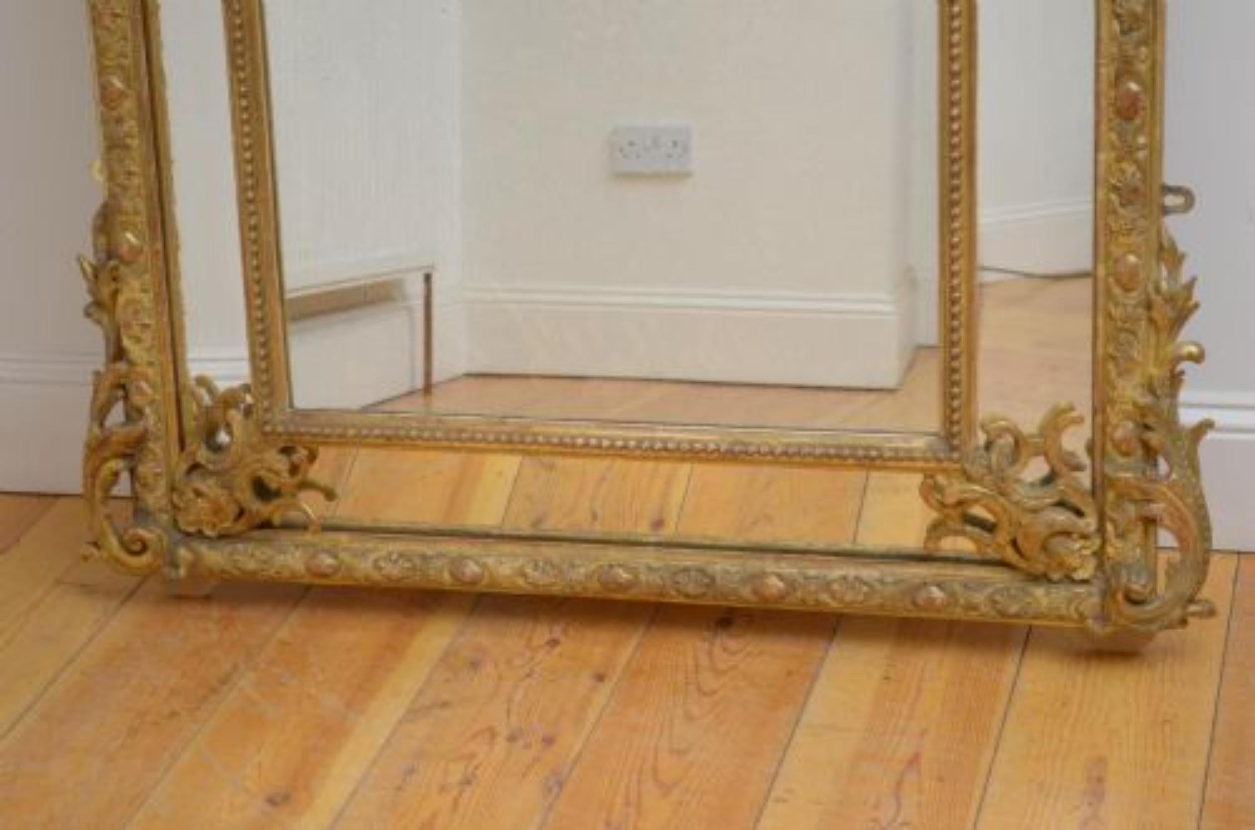 Sn5108 Superb XIXth century gilded, cushion wall mirror, having original glass with extensive foxing in beaded frame with finely carved scrolls to the base and floral swags to the centre glass, all decorated with shell crest flanked by cherubs and