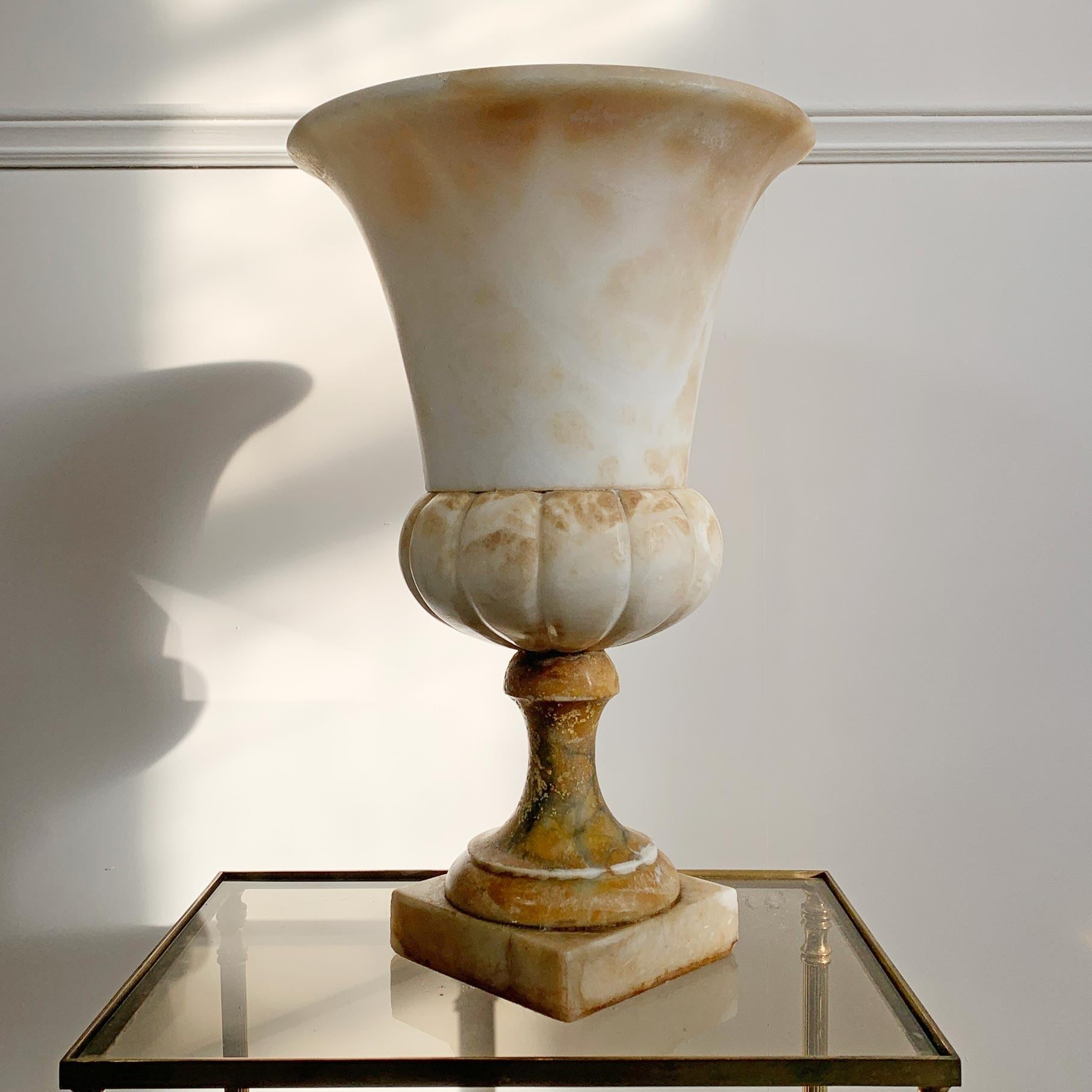 An extremely well carved large grand tour campana style urn, hand carved in Alabaster. Dating to the late 19th century. Probably Italian, made as a Grand Tour piece.

Height 44cm x Width 27.5cm

Base 13.5cm Depth inside Urn 27cm

Small loss to