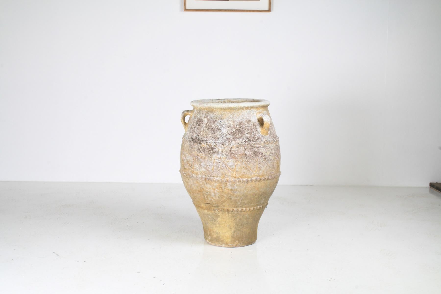 A 19th Century Greek Pithari, traditional oil jar. An old piece with elegant form, narrow base with a beautiful curvature, banded decoration bead detail and wave pattern.
Looped handles and beautiful patination with natural lichen, the piece has a