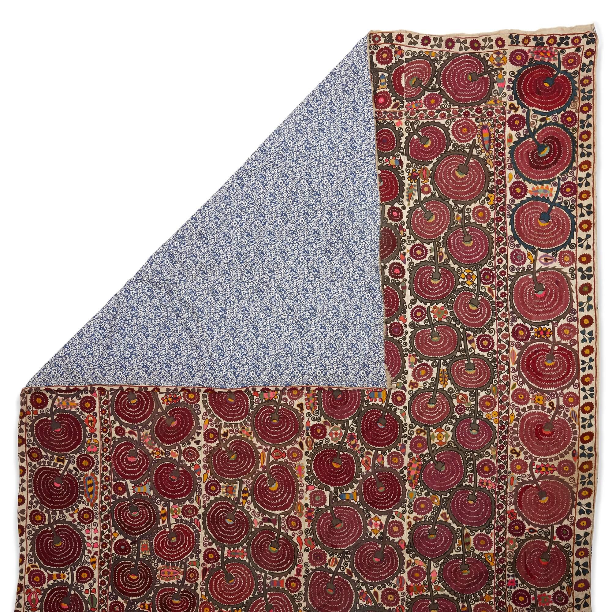 Large 19th century hand-embroidered Bukhara suzani
Uzbekistan, 19th Century
Length 280cm, width 203cm

This suzani originates from Bukhara, Uzbekistan, where it was crafted by nomadic tribes using cotton fabric and delicate hand-embroidery