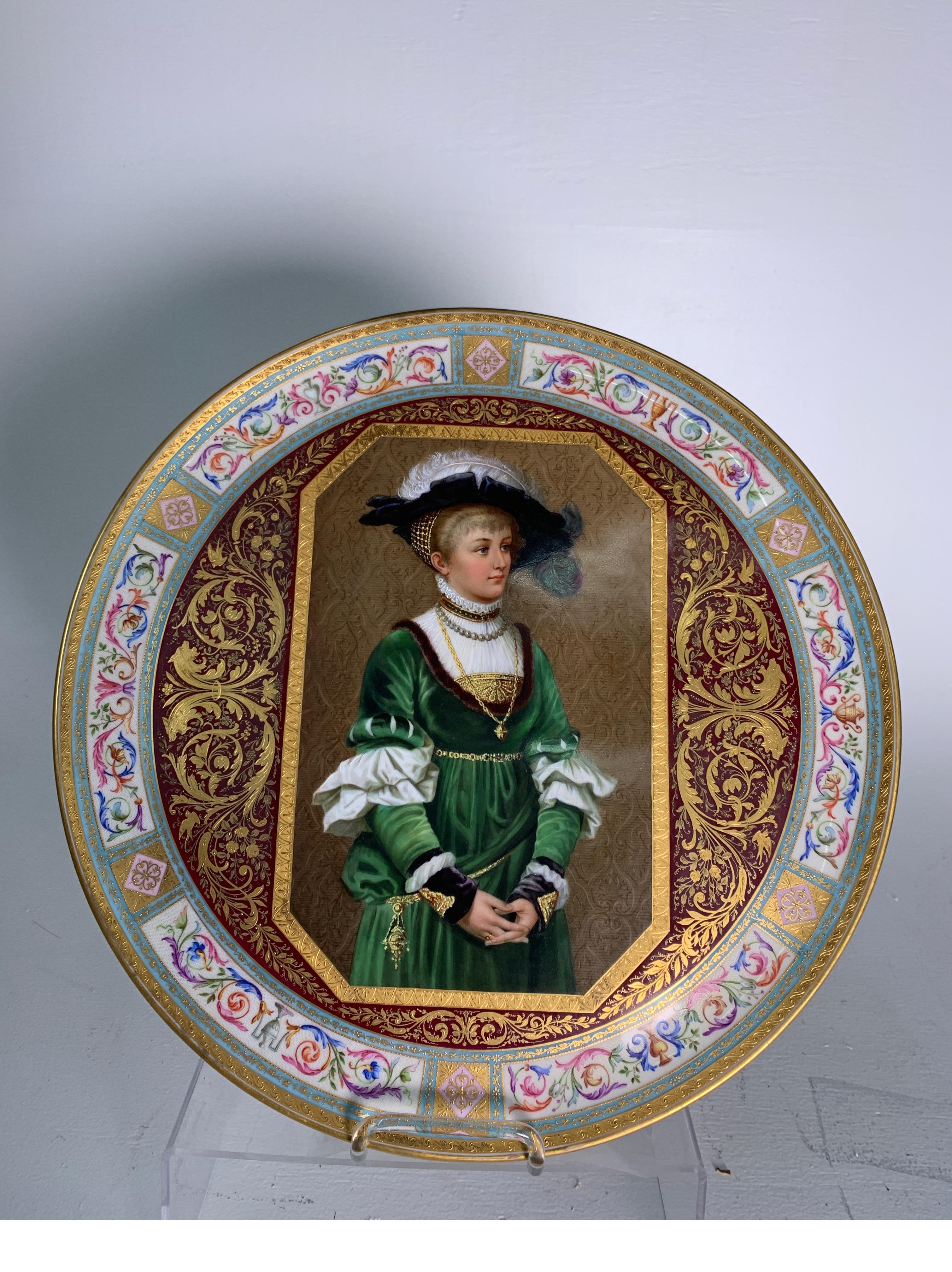 Exquisitely hand gilt and hand painted large Royal Vienna porcelain 16.75 charger with blue beehive mark on back. The raised gilding details with hand painted borders with masterfully painted central portrait. 
Painting is after Wilhelm Menzler who