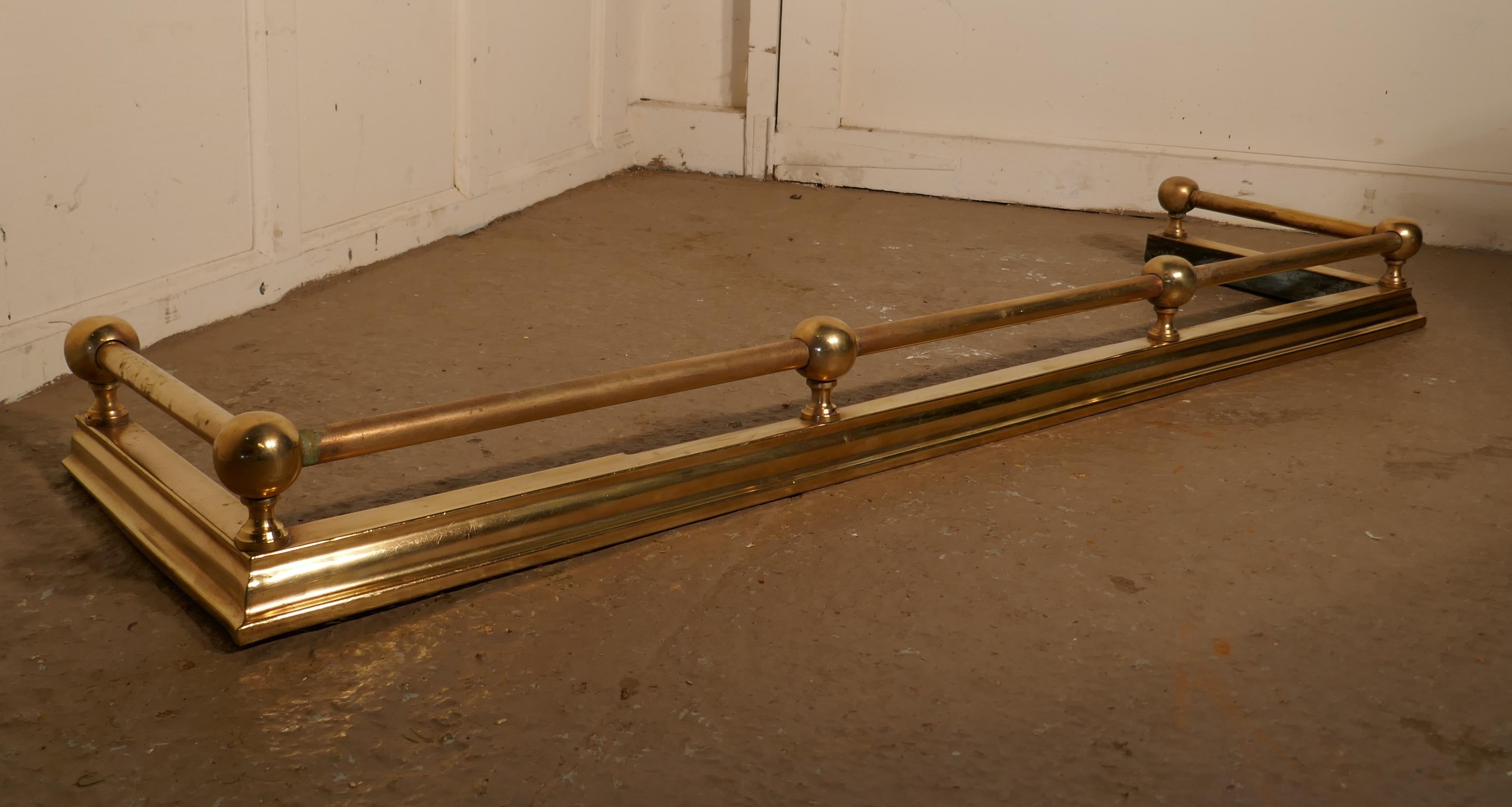 Large 19th century heavy brass fender.

This is a plain and attractive brass fender it has a simple brass base and the brass rail above has chunky brass knobs
The fender is in very good condition it is 5” high, and 54” long and 14” deep, the