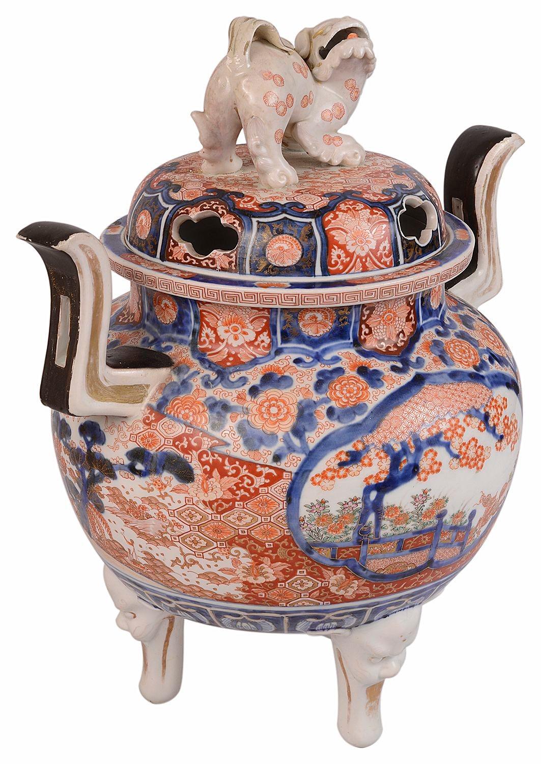 A very good quality 19th century Japanese lidded Imari Koro, in the classical bold blue and orange Imari colours, depicting classical motif flower and foliate decoration, The pierced lid with a Foo dog finial and inset hand painted panels with