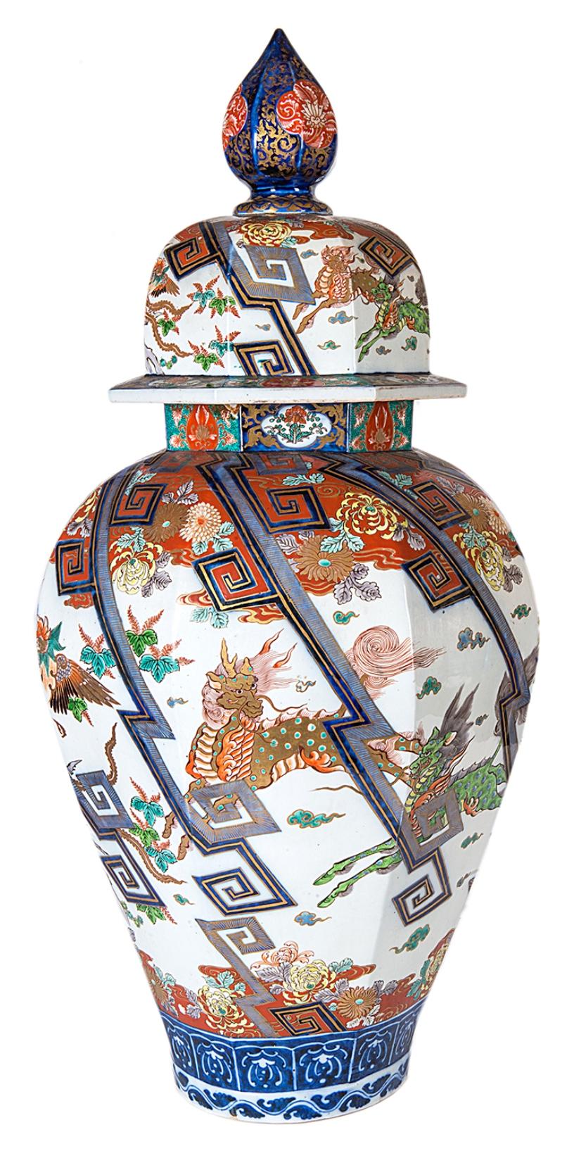 A very good quality 19th century Japanese Imari lidded vase, having mythical, horses, dogs of faux and exotic birds amongst geometric diagonal panels and boarders of flowers and foliage.