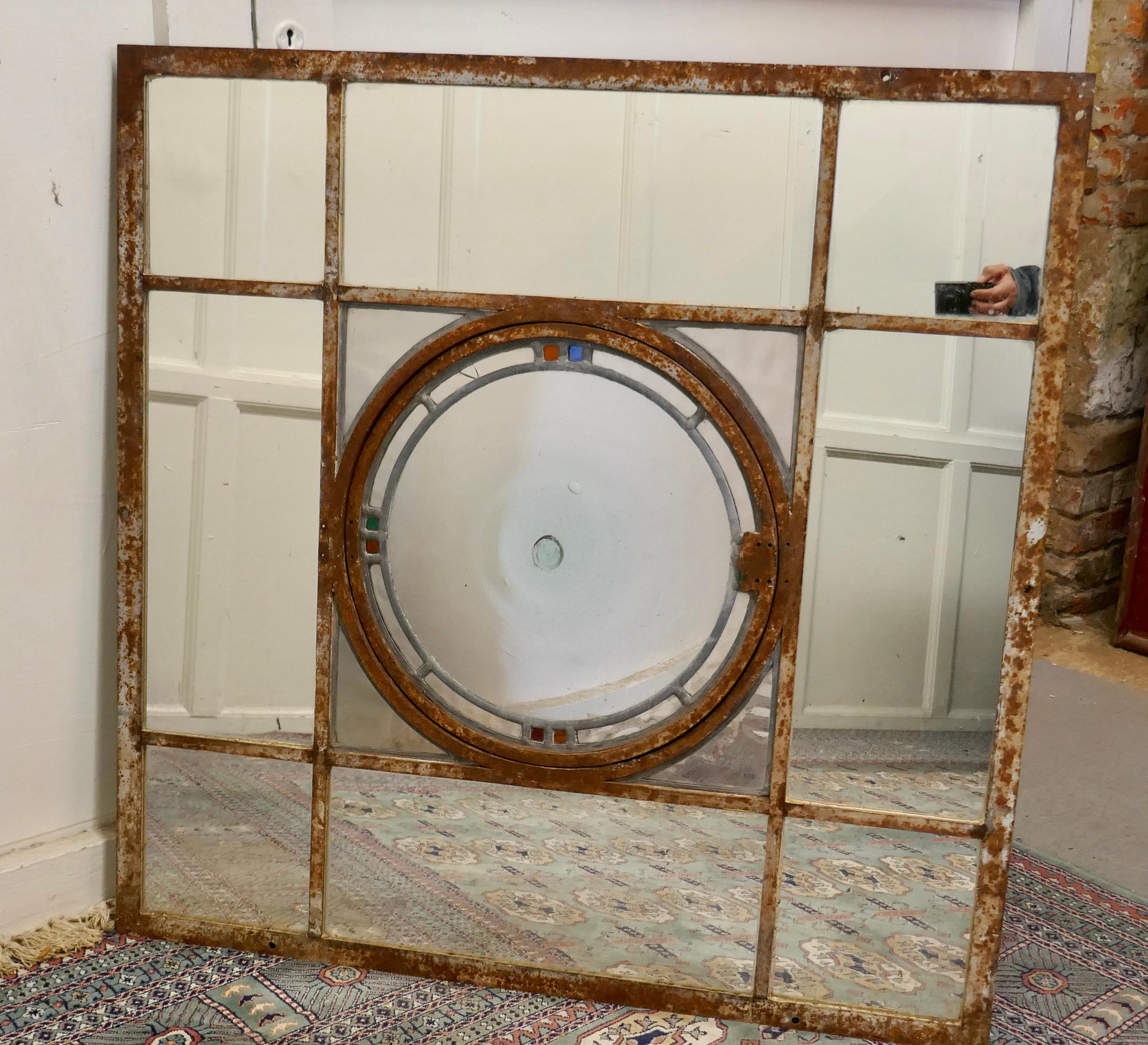 Large 19th century industrial window mirror with central leaded bottle glass opening

This large iron window frame has an original central opening circular window, the centre piece is original, it is made in stained leaded glass with a large 17”
