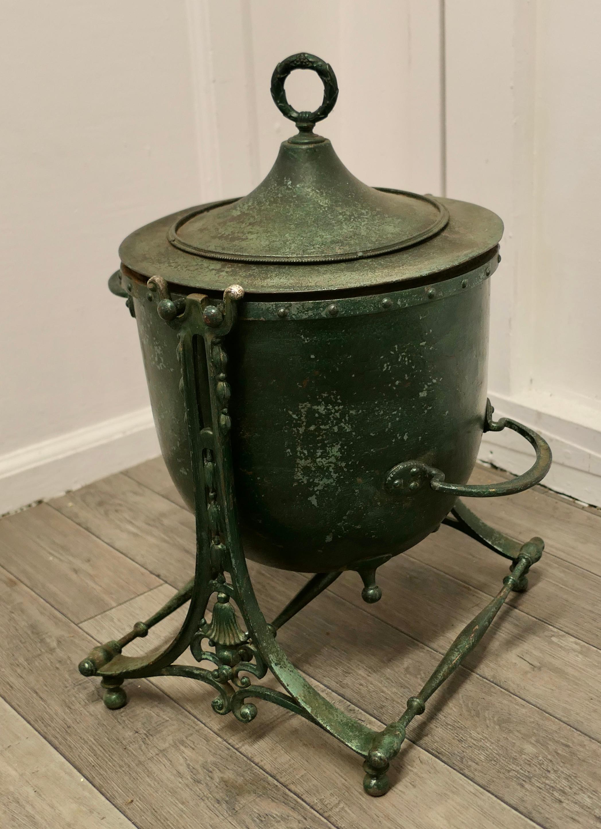 Large 19th century iron pot, cauldron on stand

This is an interesting Pot, it is made in cast iron, it has a lid and a stand on which it can be tilted.
The pot has green verdigris patination 
It is a heavy sound pot with the usual expected