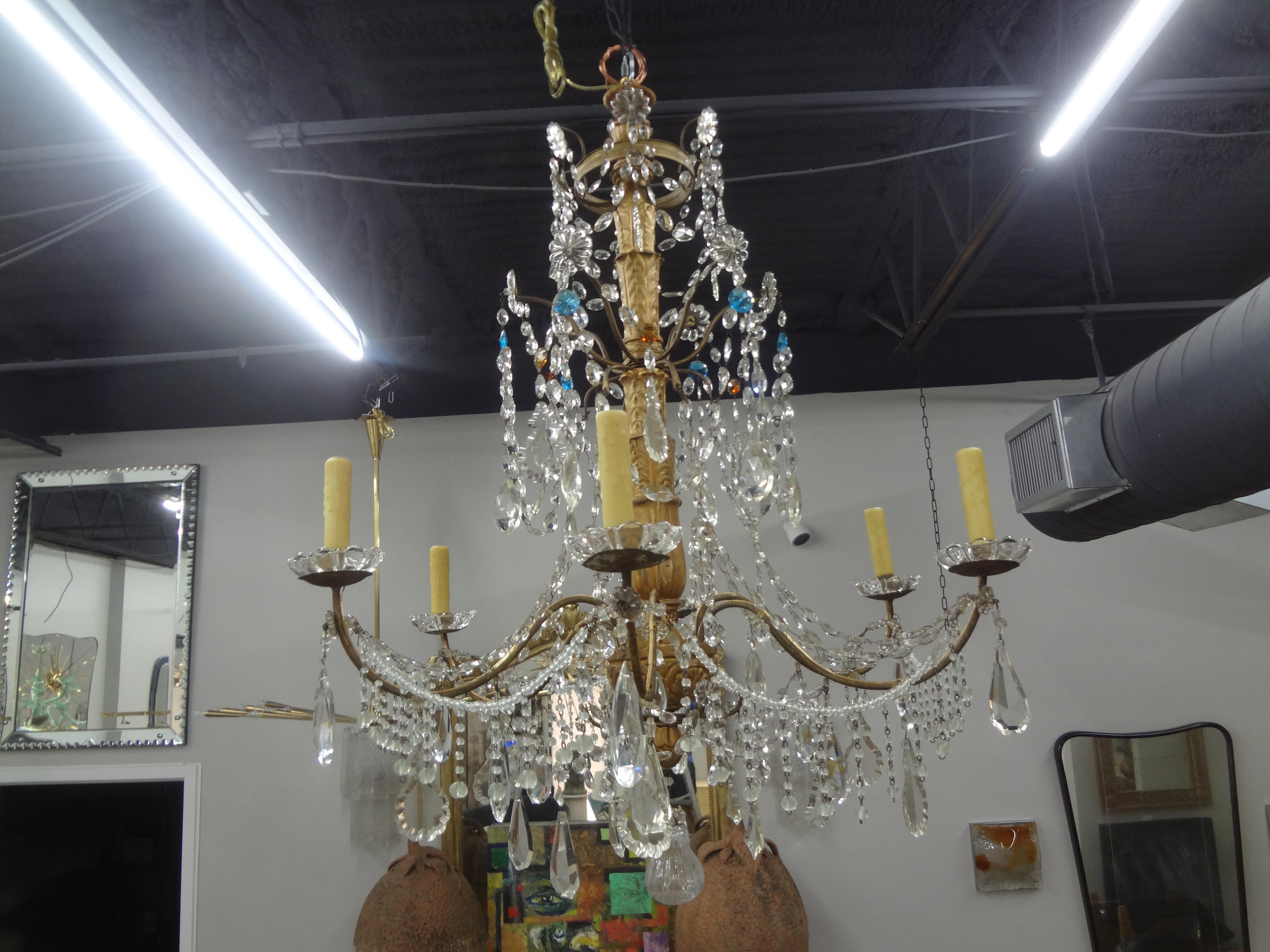 Large 19th century Italian Genovese giltwood and crystal chandelier.
This lovely antique Italian Genovese gilt wood and crystal Baroque style chandelier has been newly wired with new sockets for the U.S. market.
Stunning!