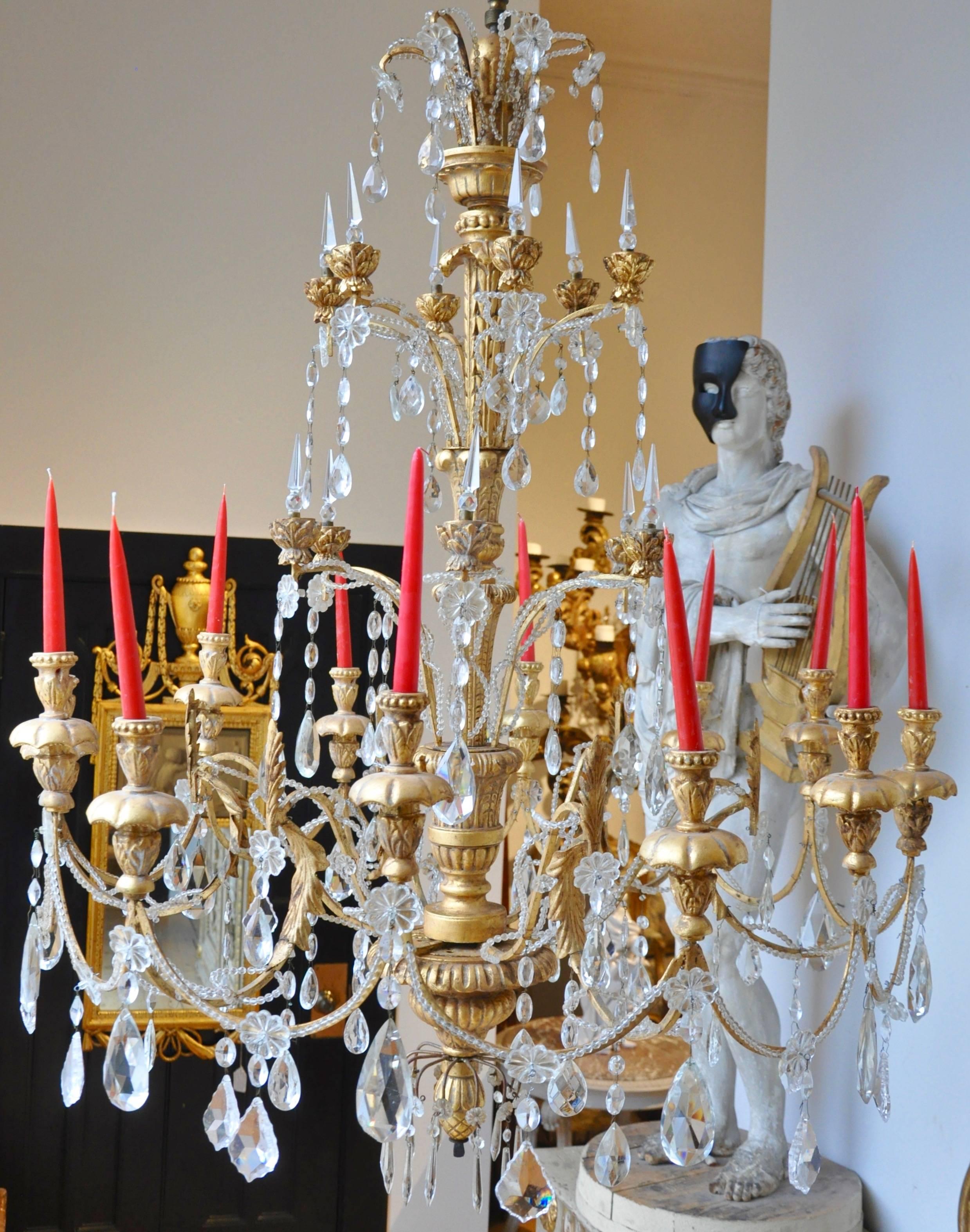 19th century Italian neoclassical giltwood and crystal chandelier

Urn form body issuing 12 arms
original crystals
Neoclassical 
Can be French wired at customer's request.