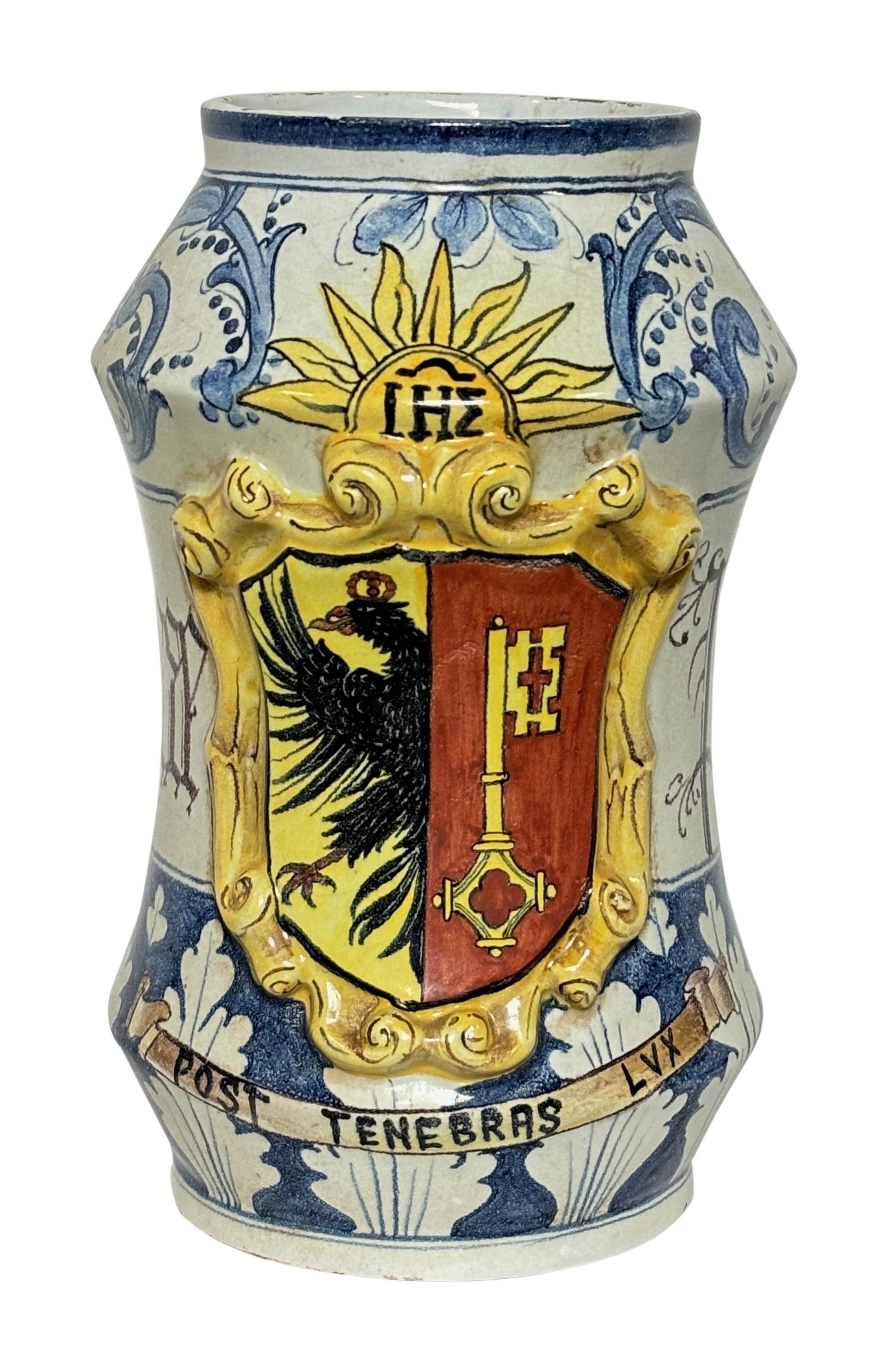 An antique 19th-Century Italian faience albarello or apothecary pharmacy jar with lid. This fine jar has an impressive hand painted crest surrounded by ornamental scrolls and foliage in blue, white and yellow colors. It displays beautifully and