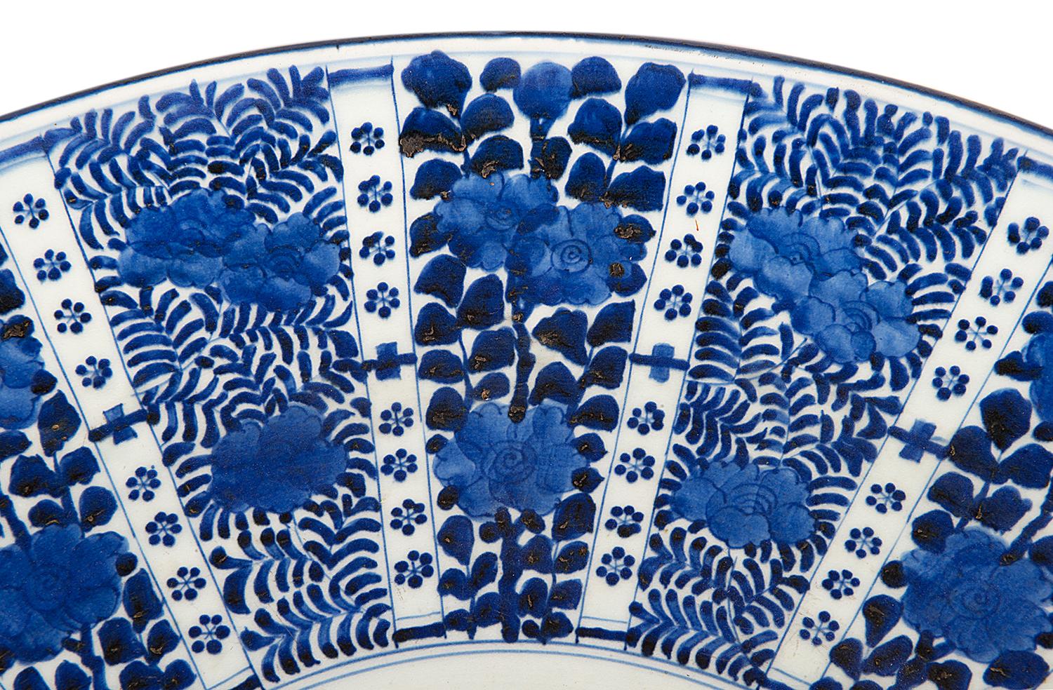 A good quality late 19th century Japanese blue and white charger, having segmented painted panels radiating out with flowers and foliage within.