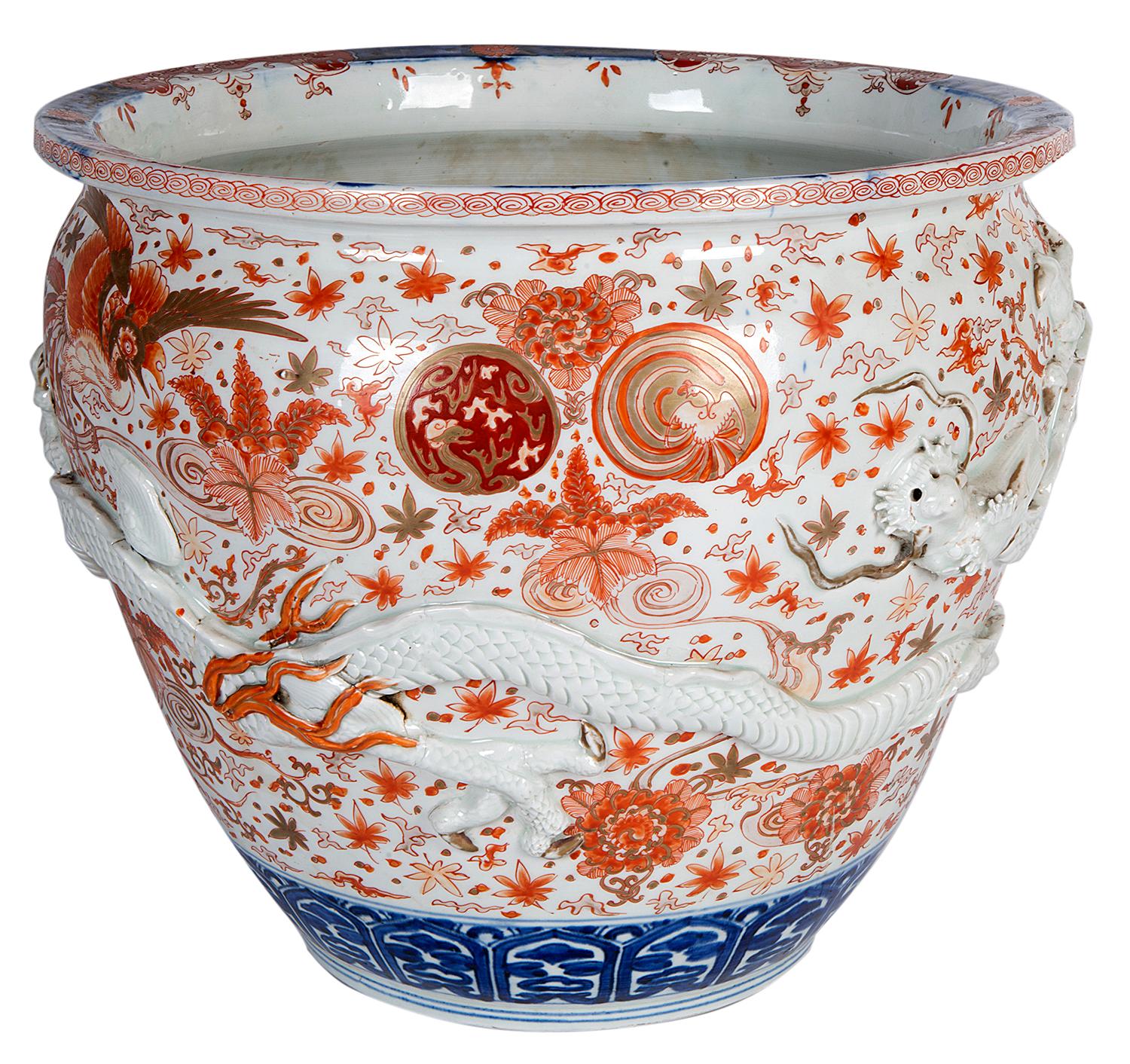 A very impressive, good quality 19th century Japanese Imari jardinière, having wonderful painted decoration of flowers, exotic birds and foliage, a mythical dragon in releaf wraps around the body.