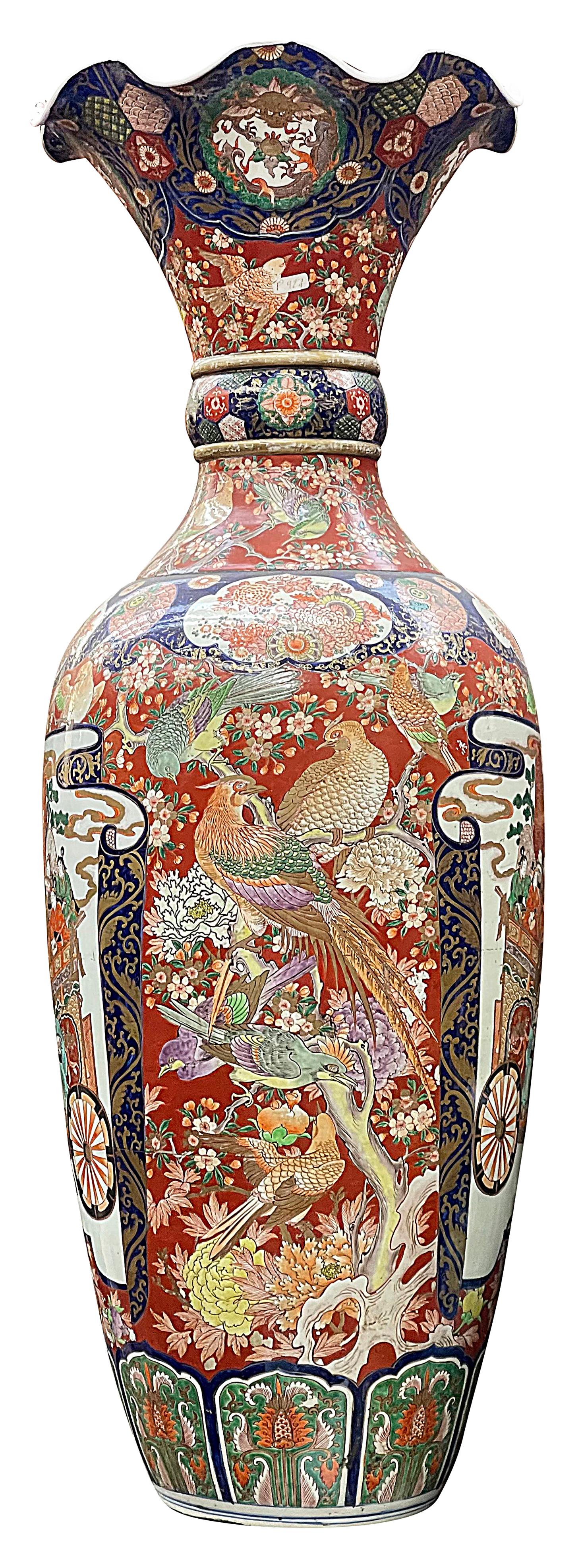 A very impressive late 19th Century Japanese Imari vase, with wonderful bold colouring, a scalloped rim classical motif decoration to the boarders, exotic flowers and birds, foliage, mythical creatures. Inset hand painted panels depicting various