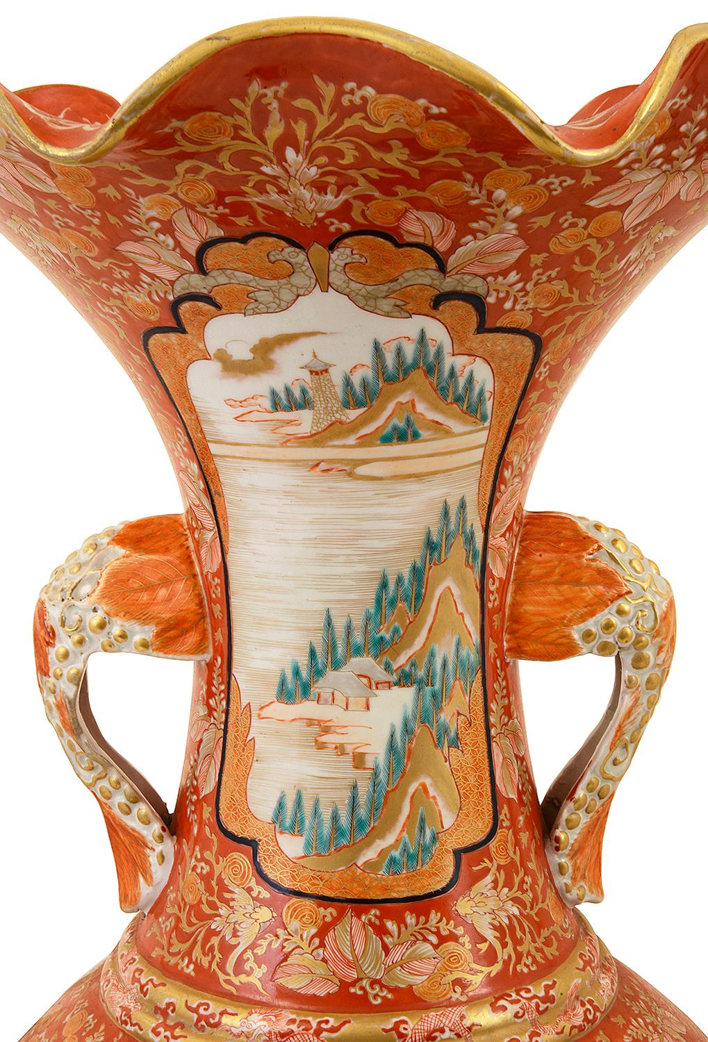 A wonderfully decorative Japanese Kutani vase, Meiji period 1868-1912. Having the classical orange ground with scrolling foliate decoration, inset hand painted panels depicting various garden scenes, mythical dragons, mountains, birds and fish.