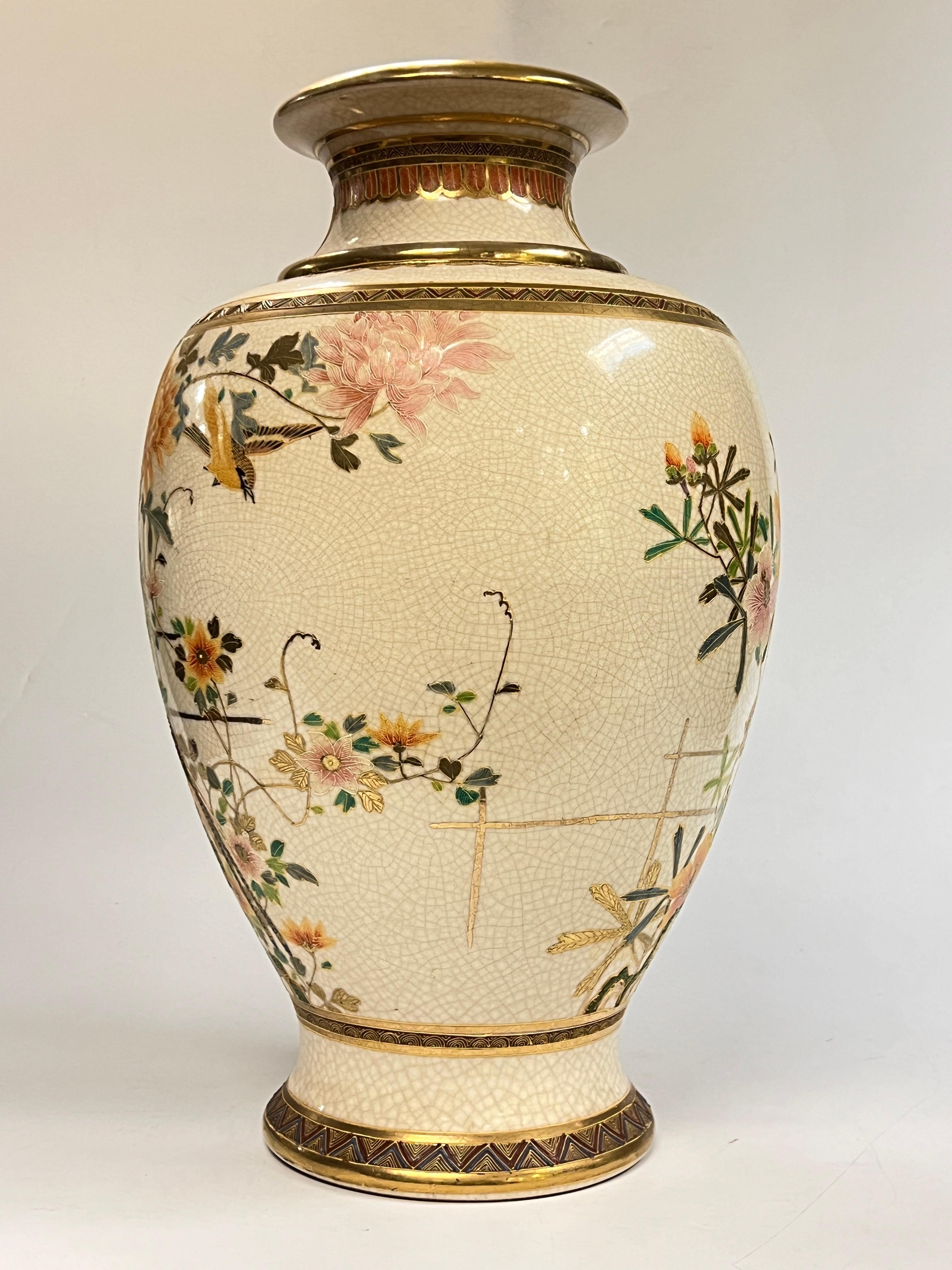 Very large (21 1/4 inch) antique (19th century) Satsuma vase with exceptional raised gilt and enameled designs of colorful flowers in bloom and an exotic bird.  Underside signed in red.