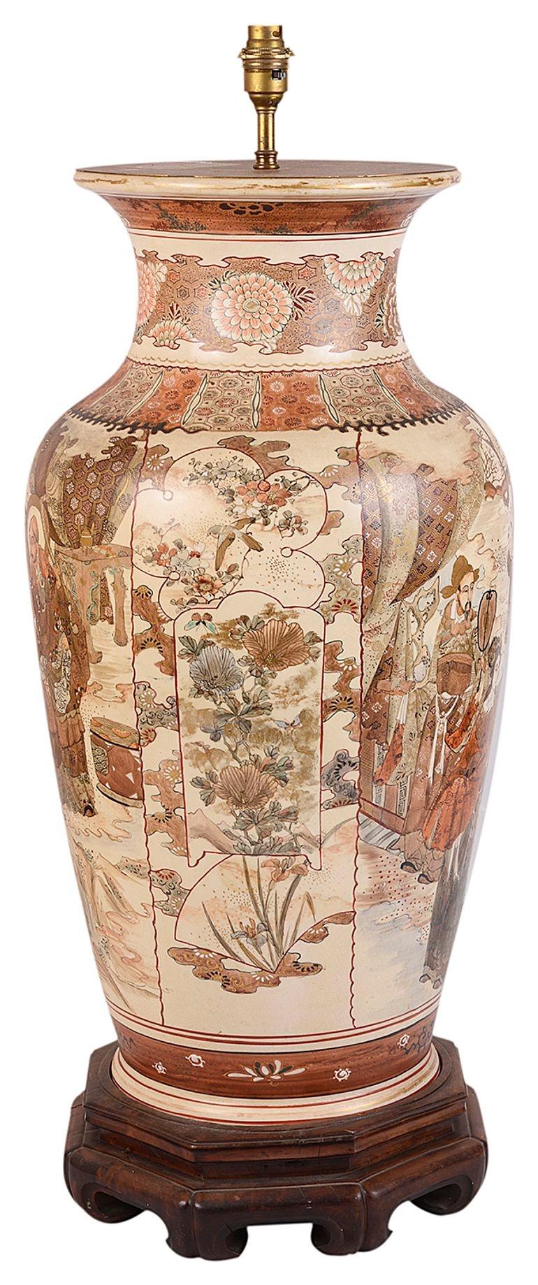 A good quality late 19th century Japanese Satsuma porcelain vase / lamp. Having wonderful classical hand painted scenes of courtiers, tradesman and children between boarders of motifs and exotic flowers, raised on a carved wooden base.
 
 
Batch