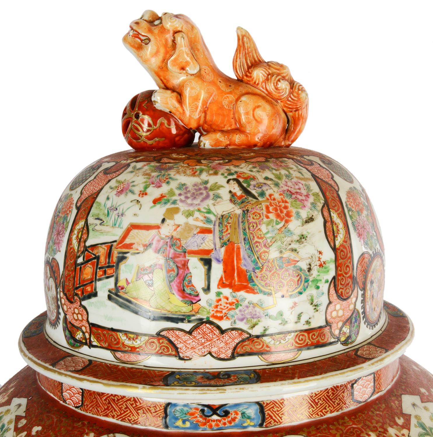 A very impressive large late 19th century Japanese lidded Kutani vase. Having a classical dog of faux with ball finial, painted scenes of scholars seated with scrolls, surrounded by attendants. The orange ground with classical motif and symbols, the