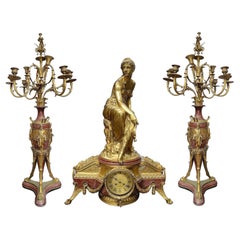 Large 19th Century Louis XVI style gilded ormolu clock set.
