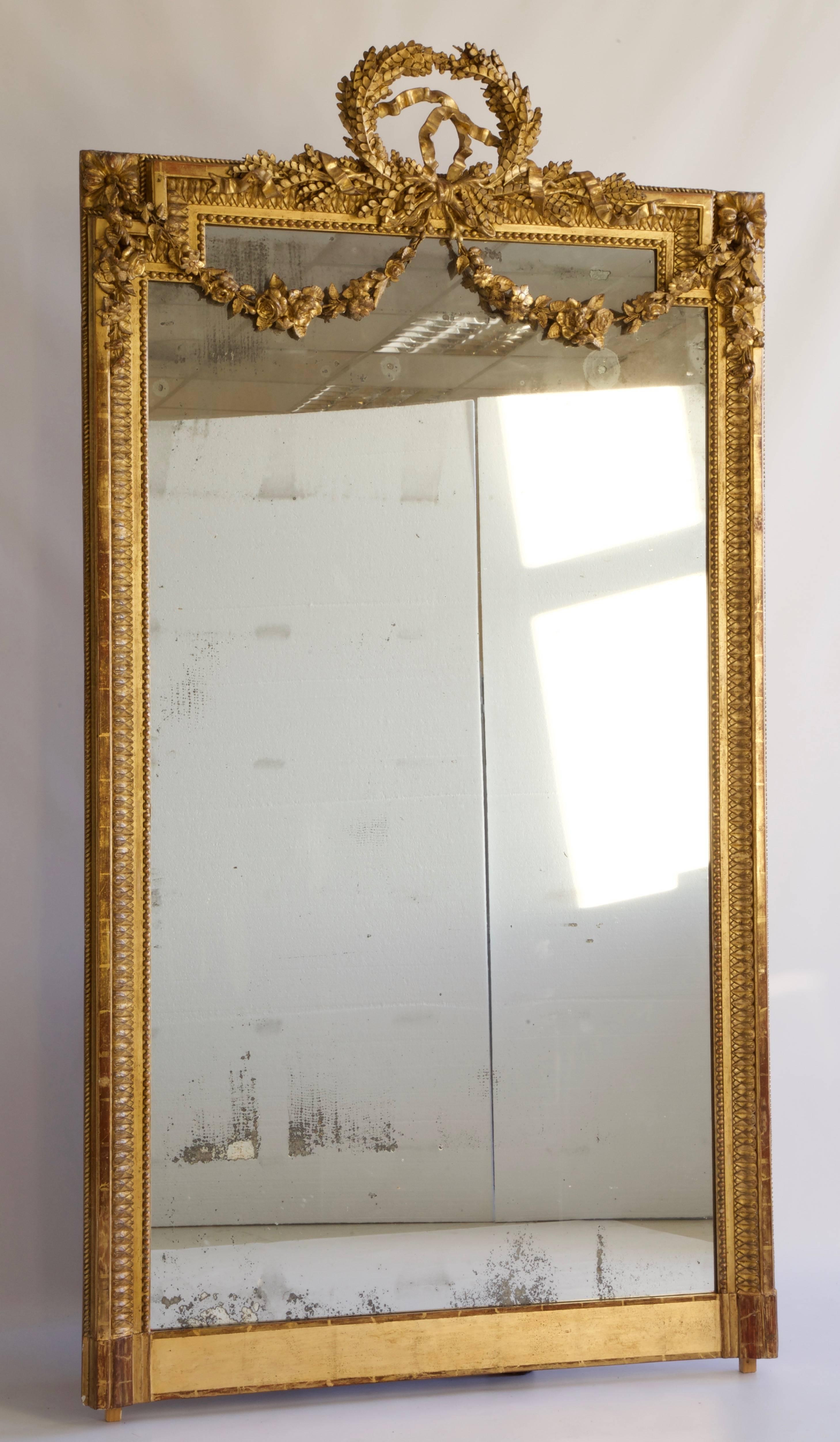 Large 19th century French Louis XVI style gold mirror.
With floral swags and a very fine ribbon.
Original Mercury Glass slightly picked in places.
Can be used floor standing as full length or hanged on a wall.