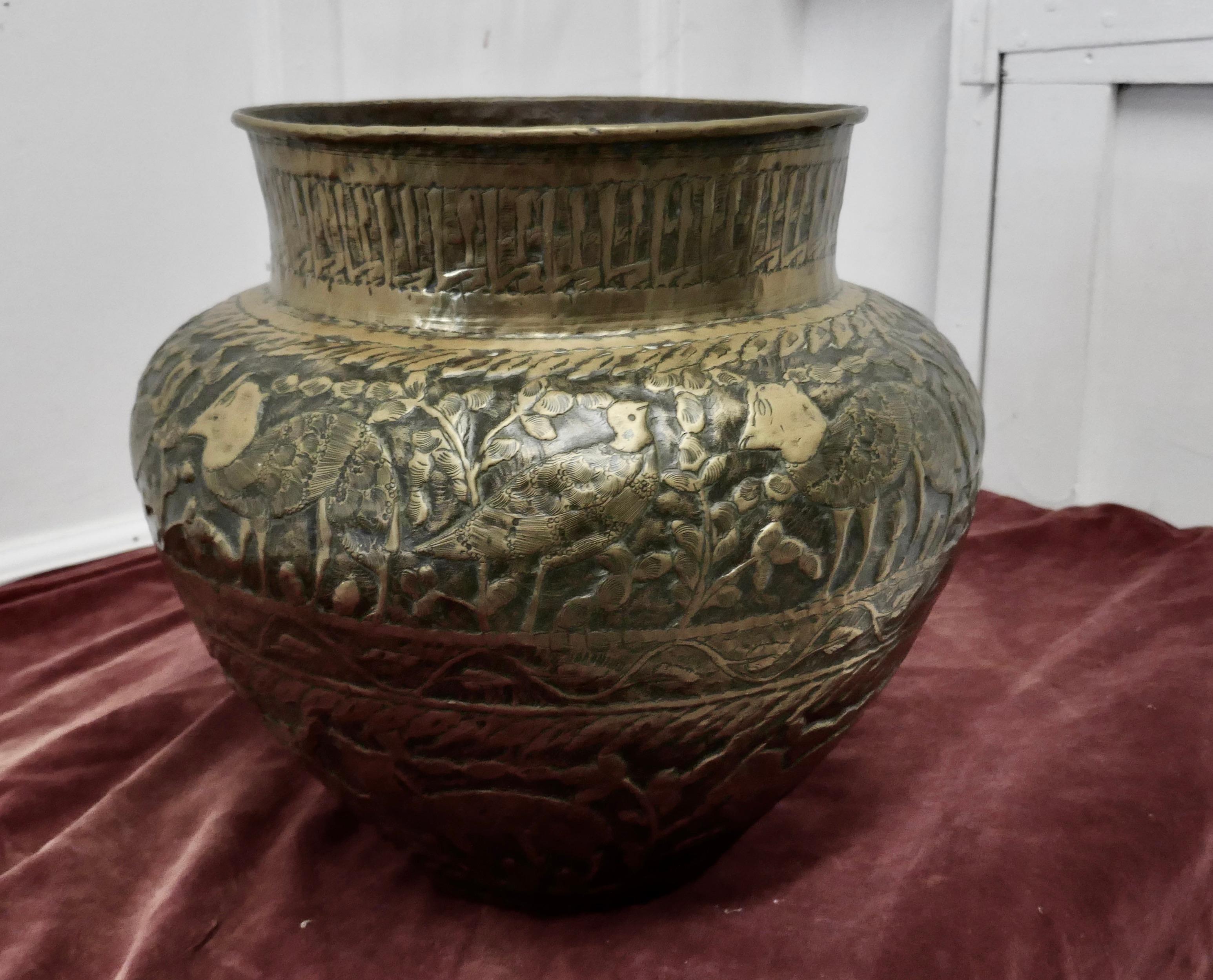 Large 19th century North African brass jardinière pot

This is a large handmade piece decorated with animals from the region and with a deep brass collar at the top of the vase
The pot is a wonderful looking piece with natural patination
In good