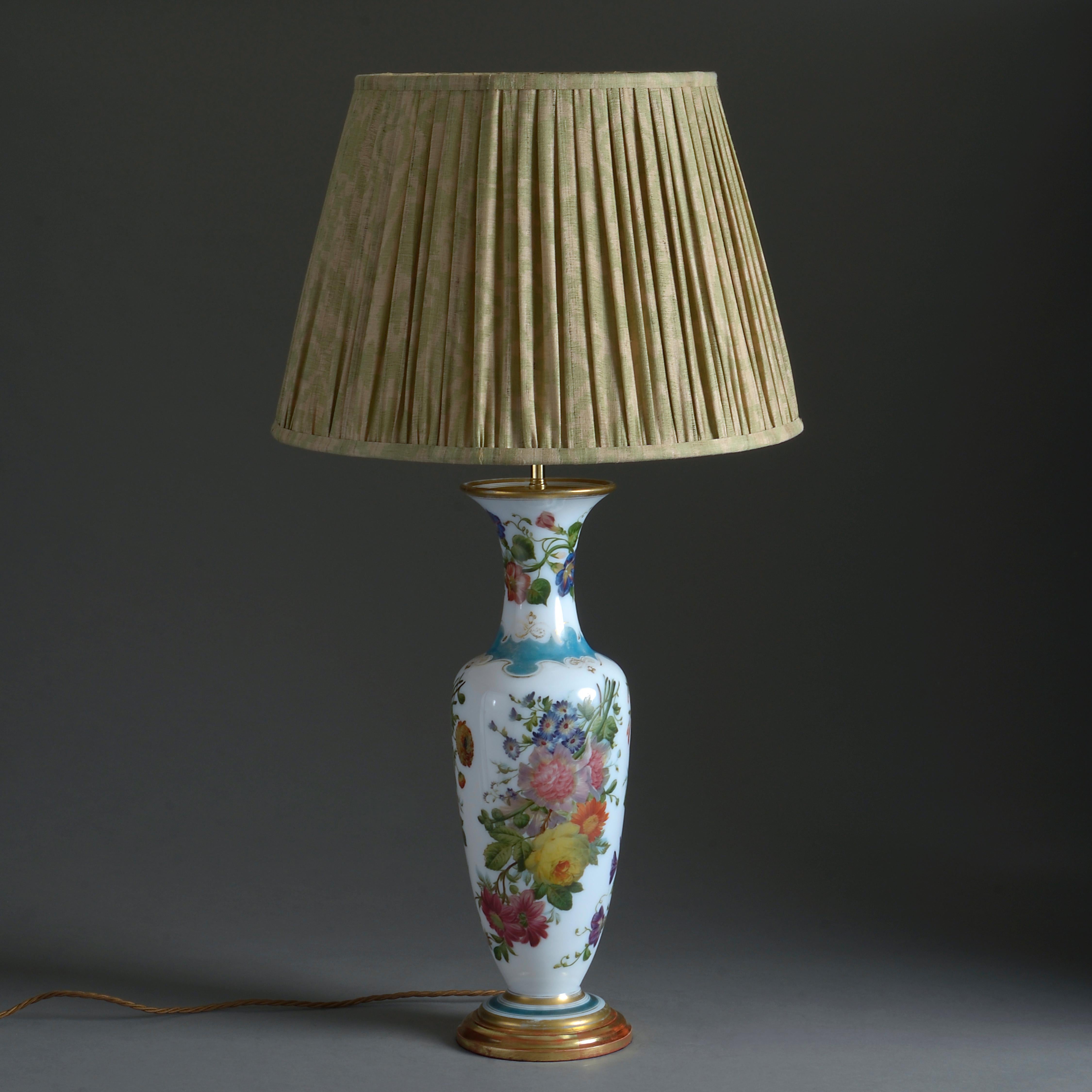 A mid-19th century opaline glass vase of good scale, the body naturalistically decorated throughout with polychrome flowers. Now mounted as a table lamp.

Height dimension refers to antique parts only (excluding electrical components).

All