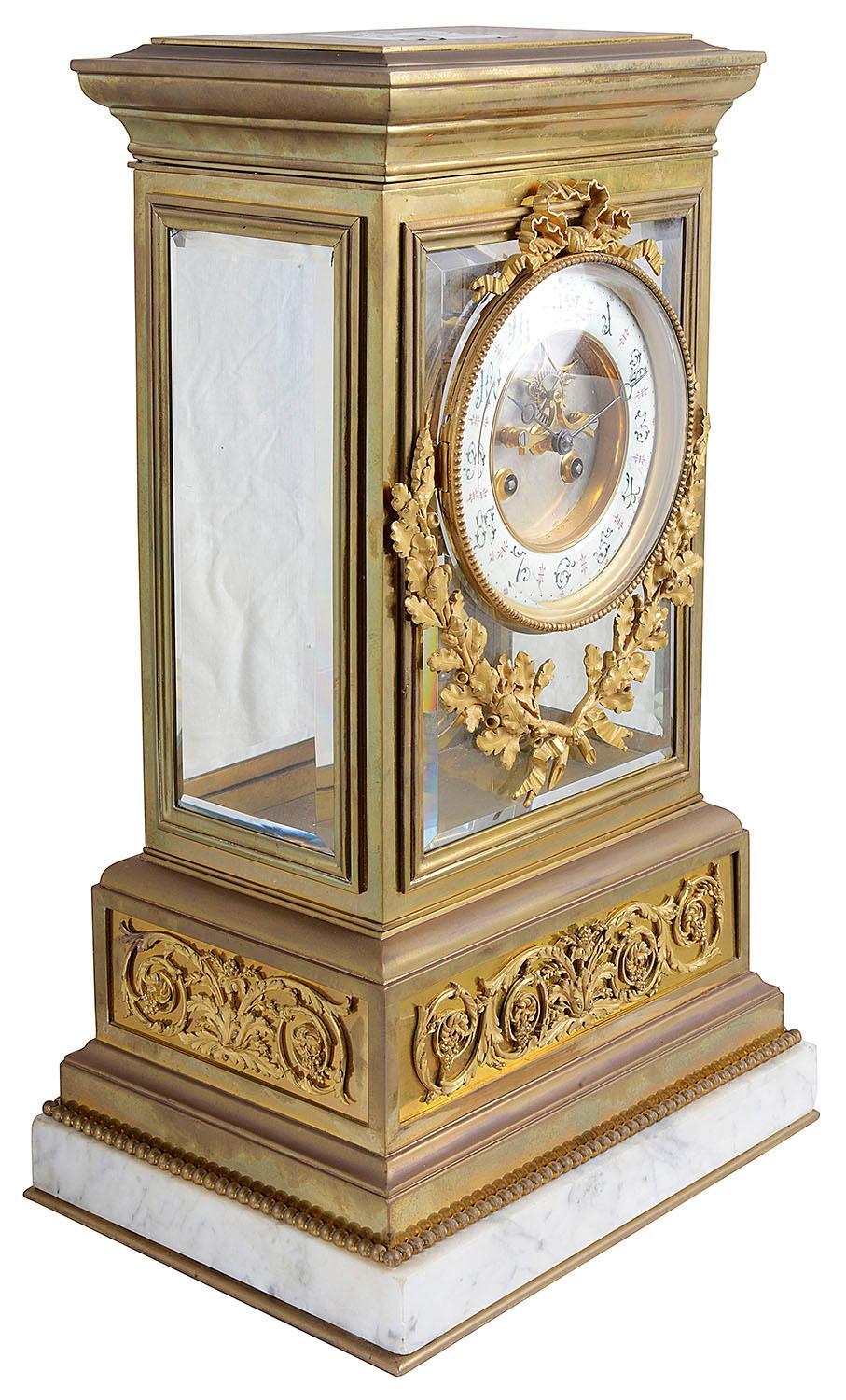 A large very good quality late 19th century gilded ormolu four glass mantle clock, having oak leaf and Acorn branch mounts beneath the enamel clock face with roman numerals, an eight day duration movement that strikes on the hour and half hour.