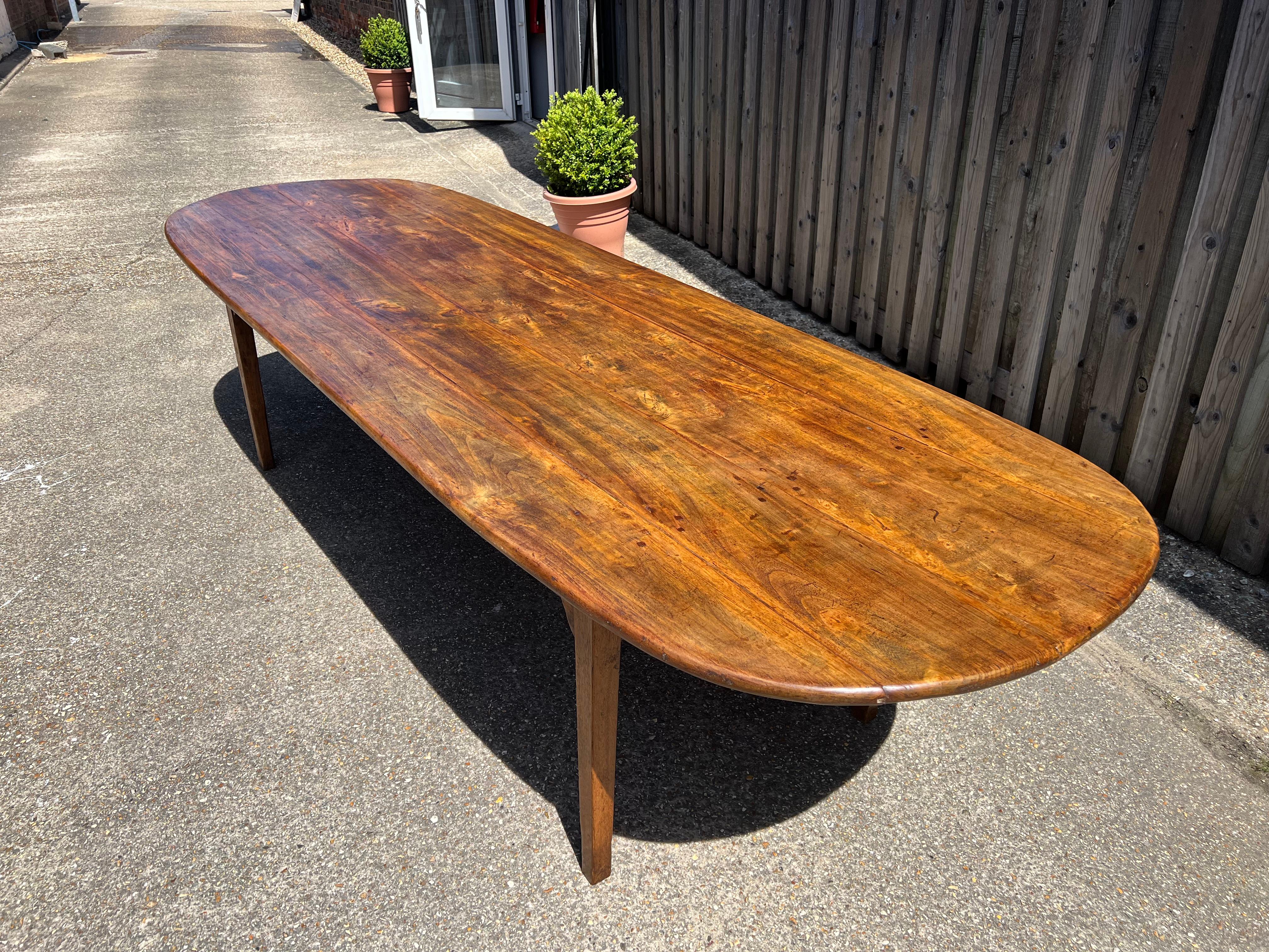 Mid 19th century oval ended table with four plank top. The table sits on beautiful tapered oak legs and oak base. Gorgeous colour and patina. The table has brackets on apron and the table top is sturdy and wide with a rustic feel to it. 
      
