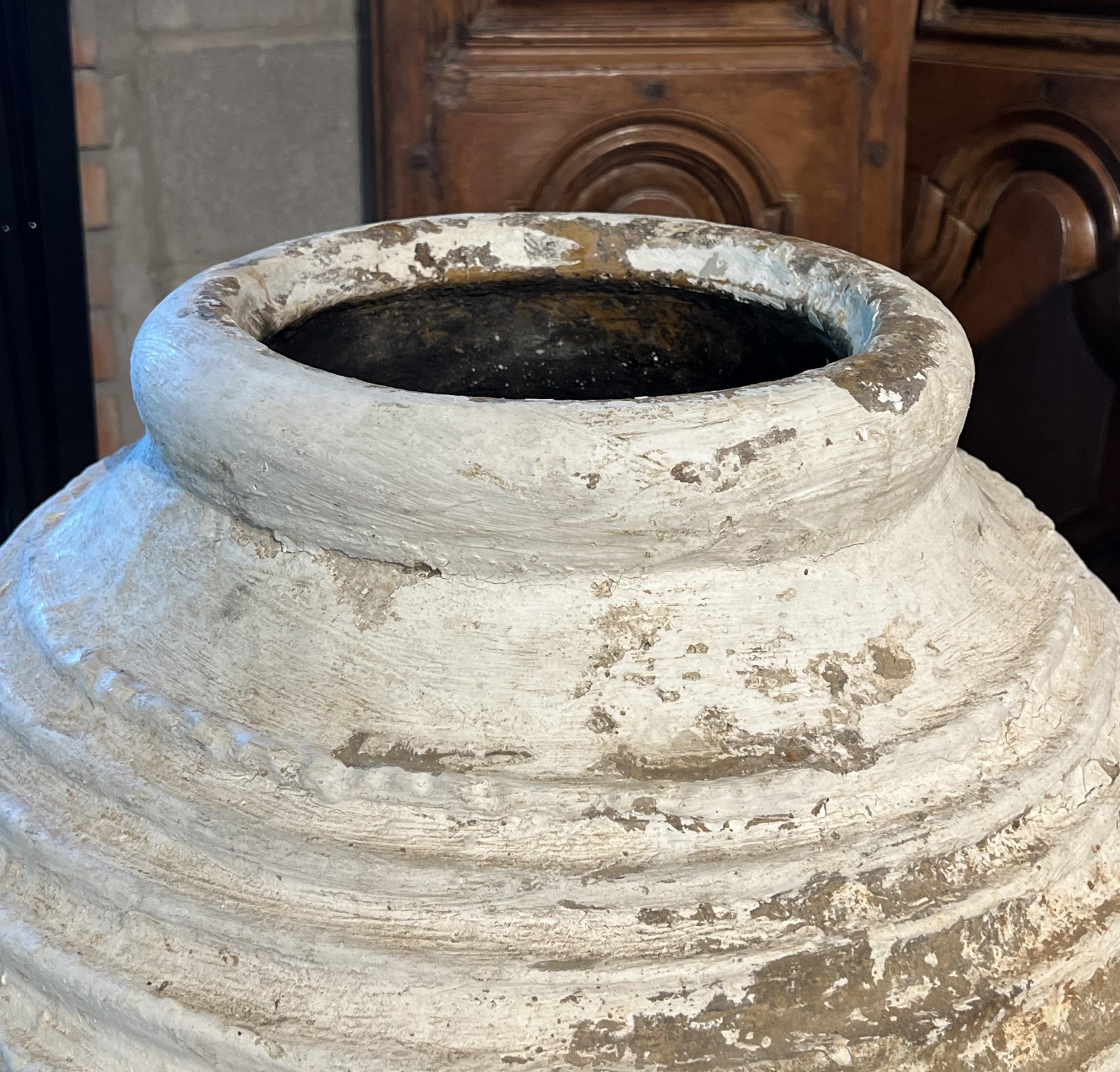 Weitere Informationen folgen in Kürze...

Dieser gerippte Topf wurde in der griechischen Region Peloponnes in den späten 1800er Jahren zur Aufbewahrung von Olivenöl oder Wein verwendet. Die enge Öffnung (im Vergleich zum bauchigen Körper) hätte dazu