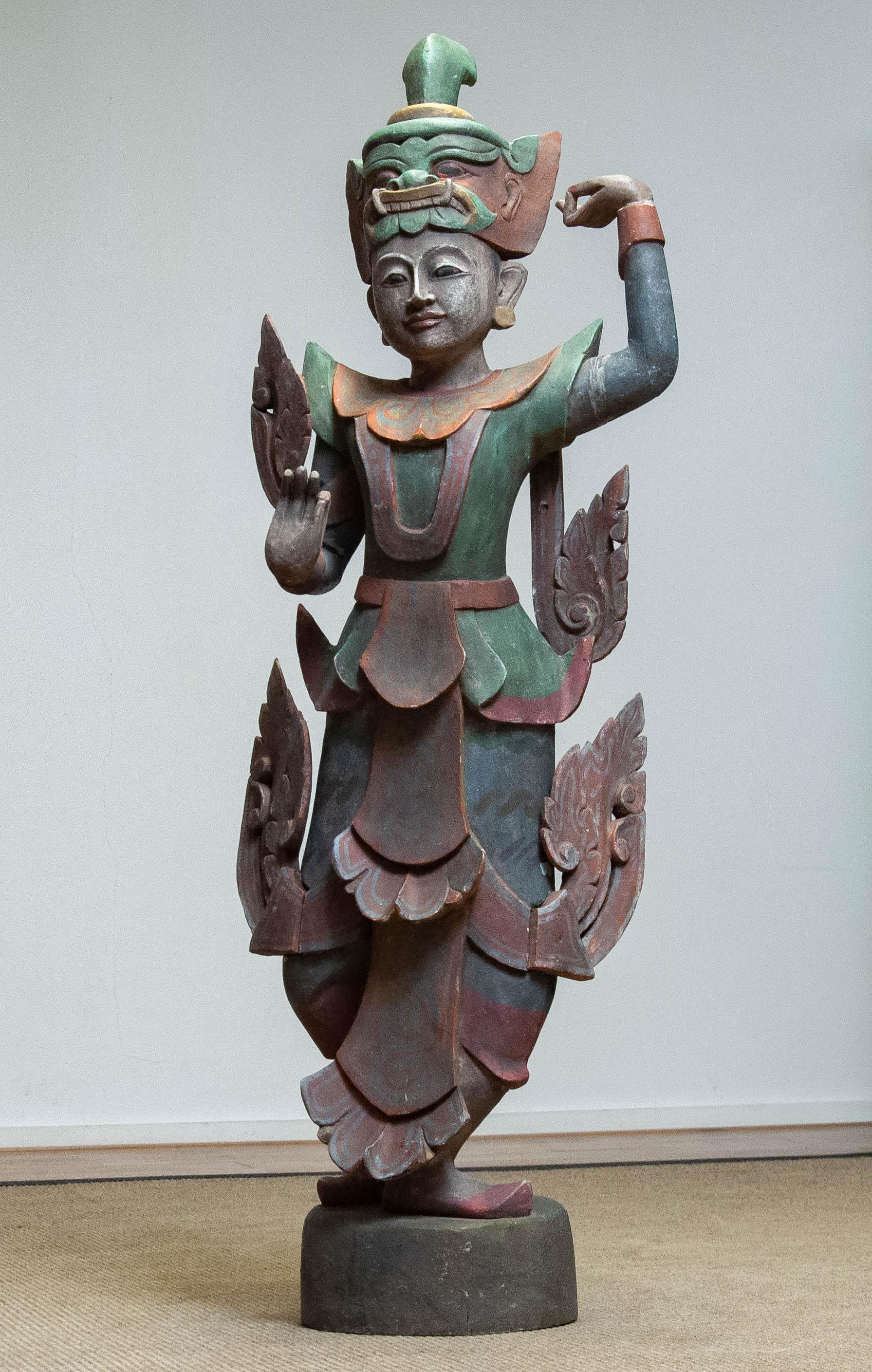 Hand-carved wooden sculpture representing a traditional guardian or deity figure, often referred to as the 