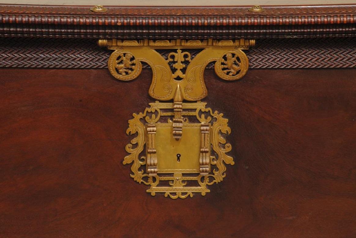 An impressive 19th century Portuguese teak coffer on original bun feet. The trunk retains the wonderful original gilt brass engraved metal work including the lock plate, and is covered in amazing ripple moulded work
Superb colour and patina.