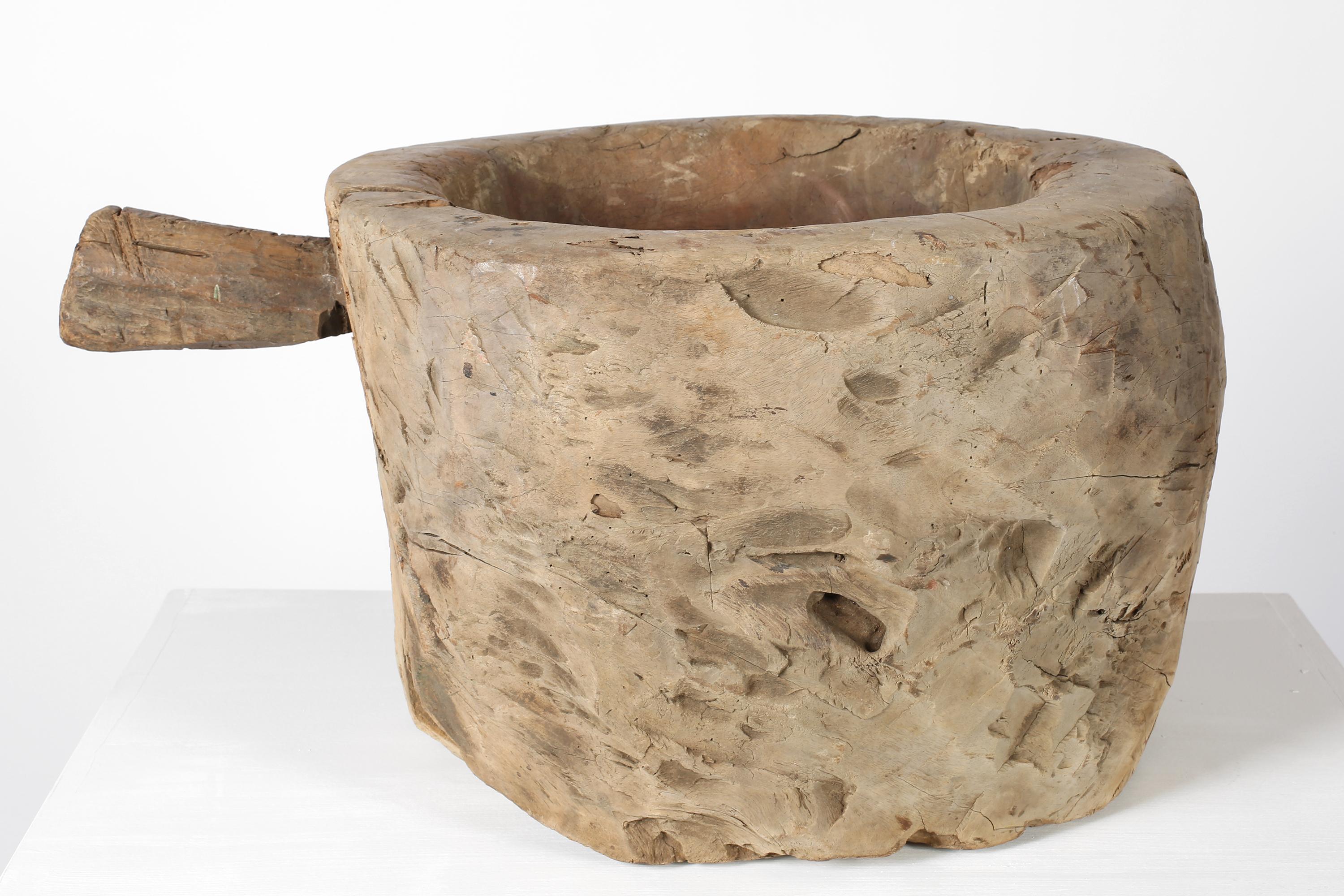 A monumental early 19th century mortar, primitively carved from a single piece of, now beautifully patinated, chestnut timber. French, c. 1800.