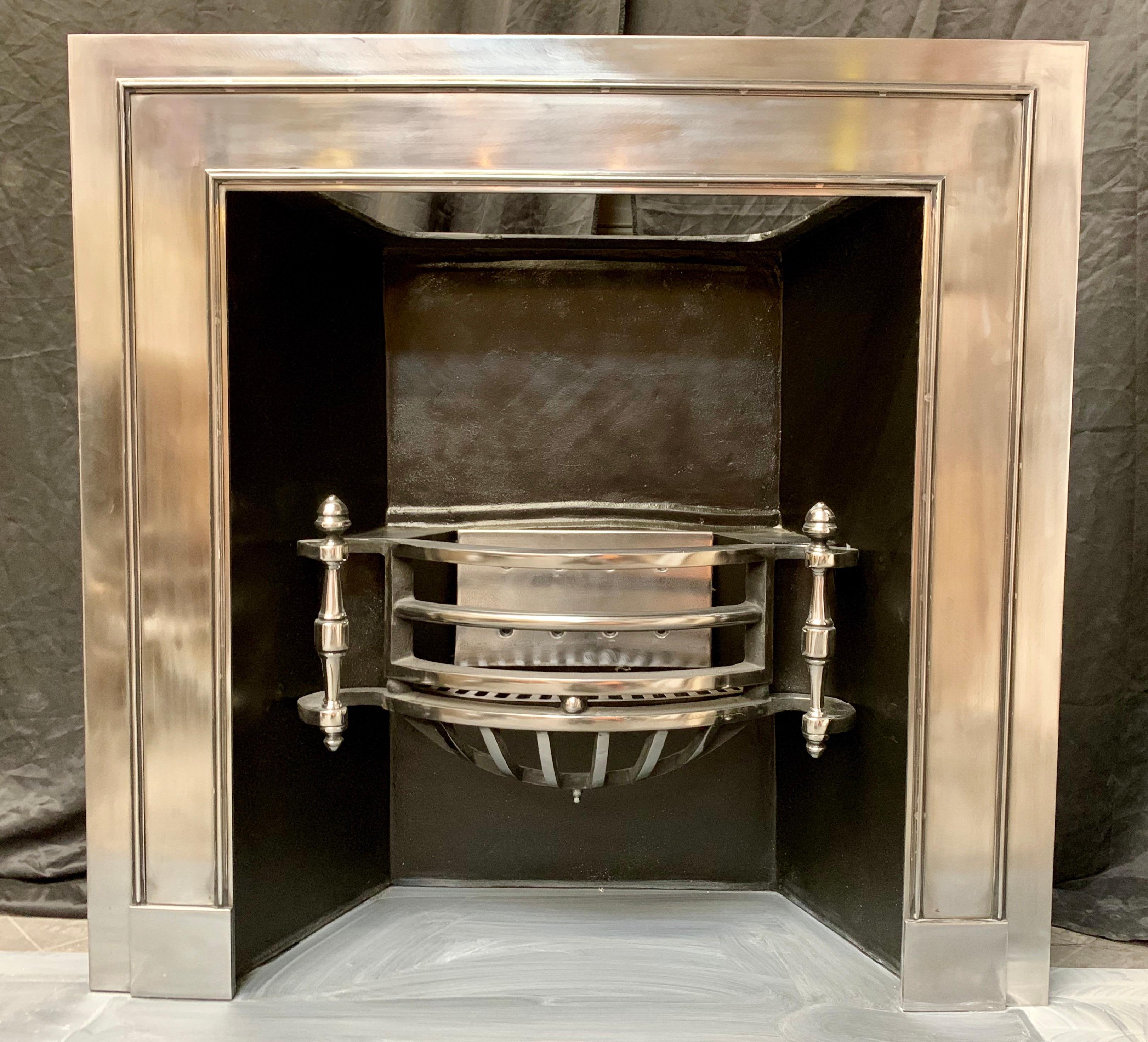 A charming 19th century Regency style polished steel fireplace insert of high quality, a large polished steel outer frame with applied tram line moulding finishing on square plate blocks, connecting a generous splayed fireplace chamber hosting a