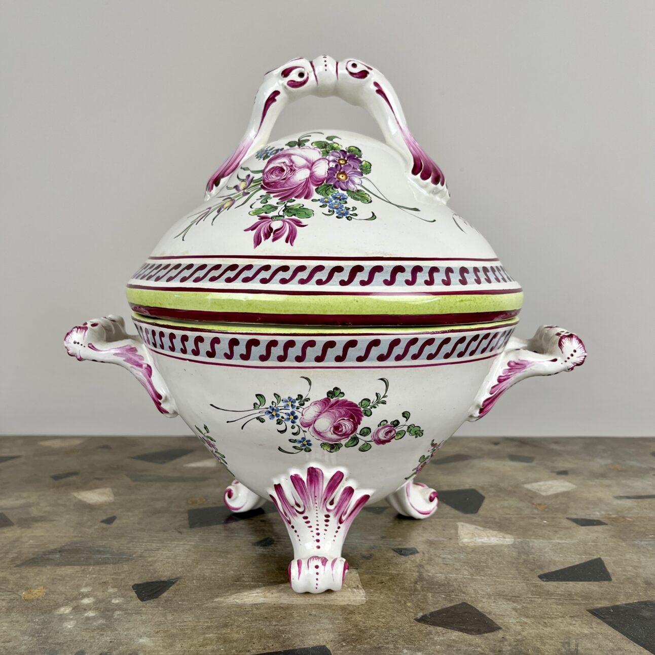 A large cauldron-shaped French faience tureen raised on scrolling tri-form feet, with twin handles and domed lid decorated with hand-painted sprays of roses and borders of vitruvian scrolls. This tureen was made in France in the late 19th century