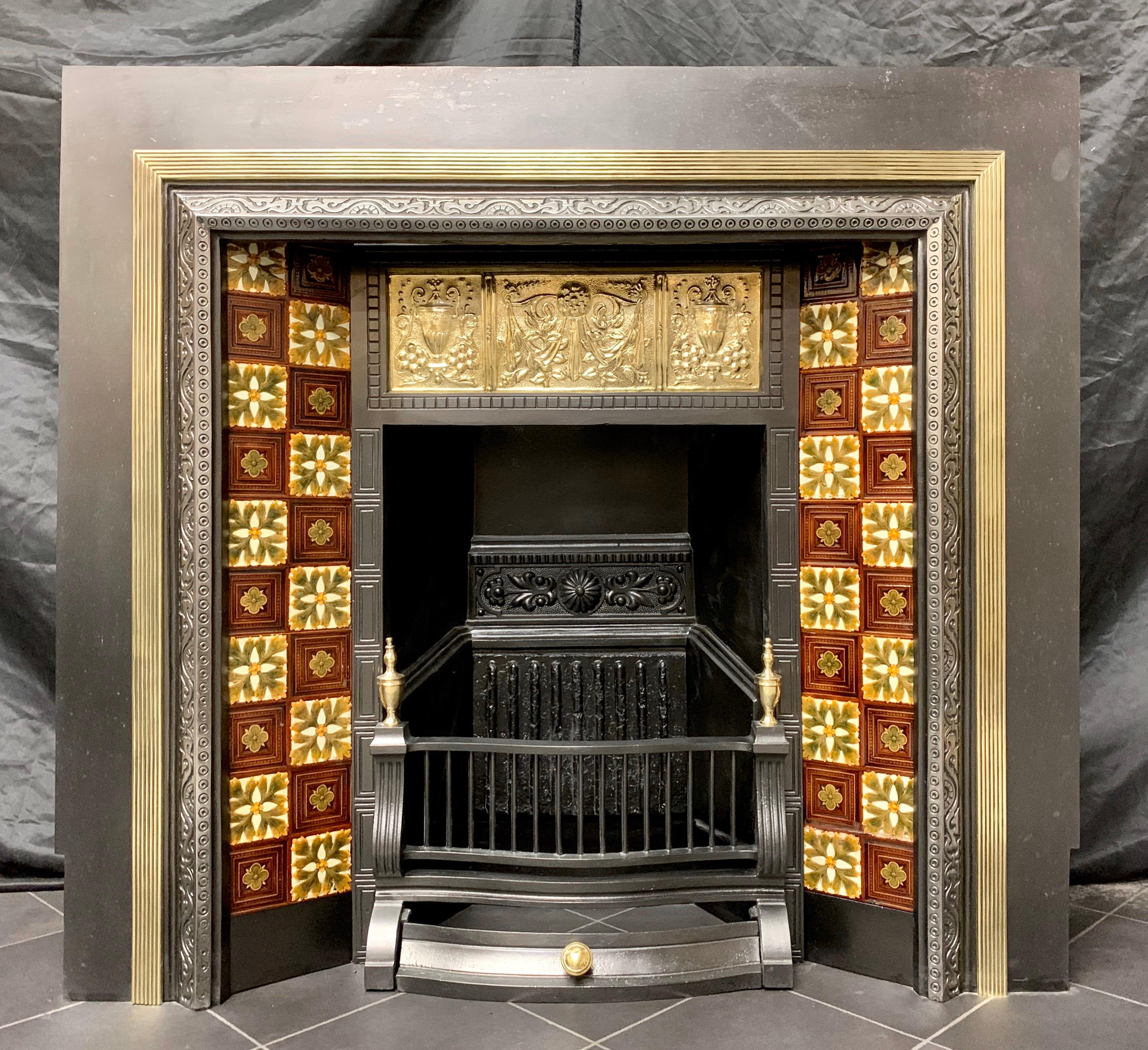 A most unusual and charming example of a large 19th century Scottish cast iron and brass fireplace insert, a large cast iron outer frame hosts a frame of reeded brass moulding with a splayed and highlighted casting of daisies swirls, the original