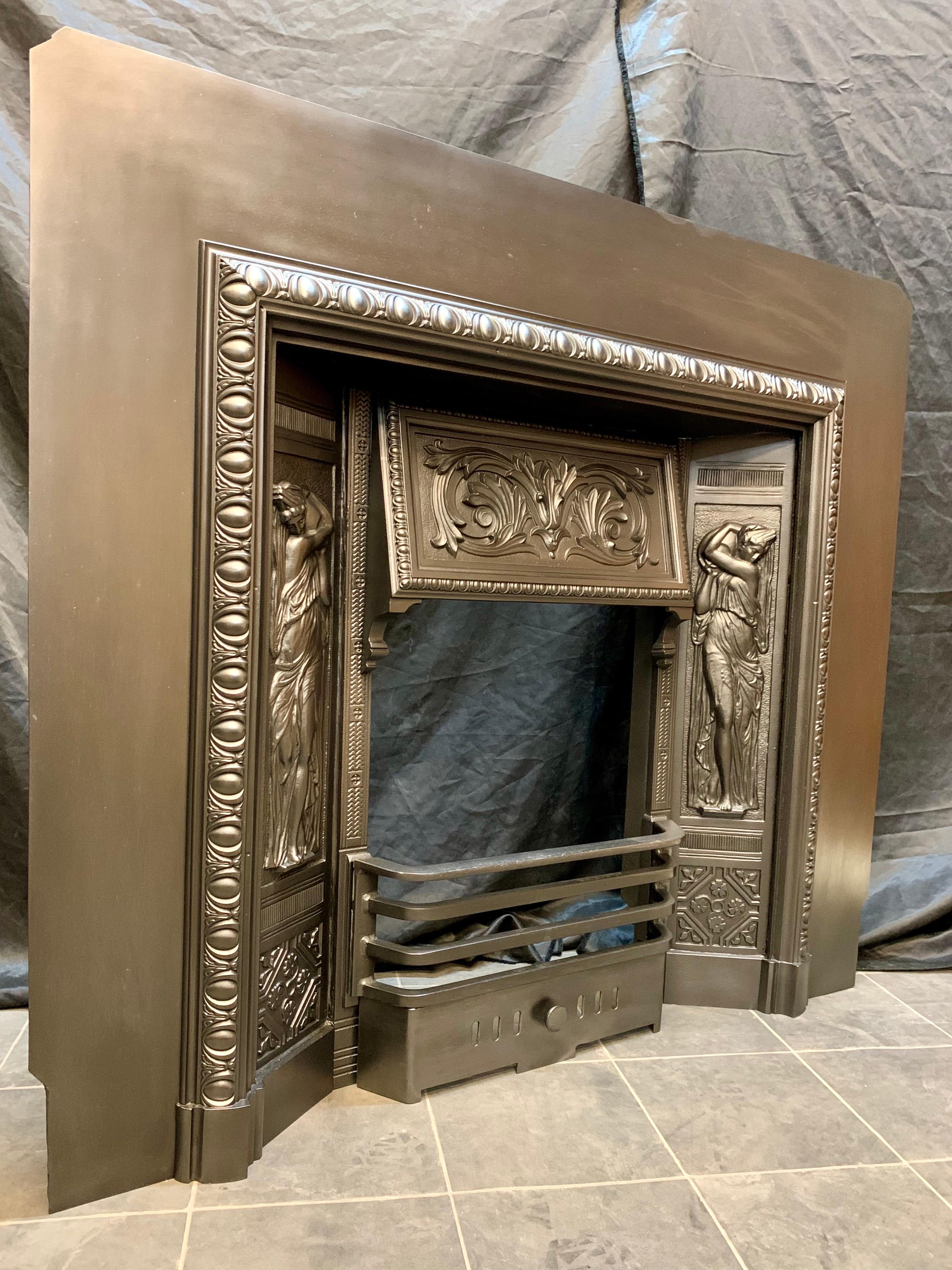A larger than normal Scottish 19th century Victorian cast iron fireplace insert by Carron of Falkirk. A very generous outer plate (47' wide) hosting a framed border of egg & flower, terminating onto shaped foot blocks, a protruding fire hood with a