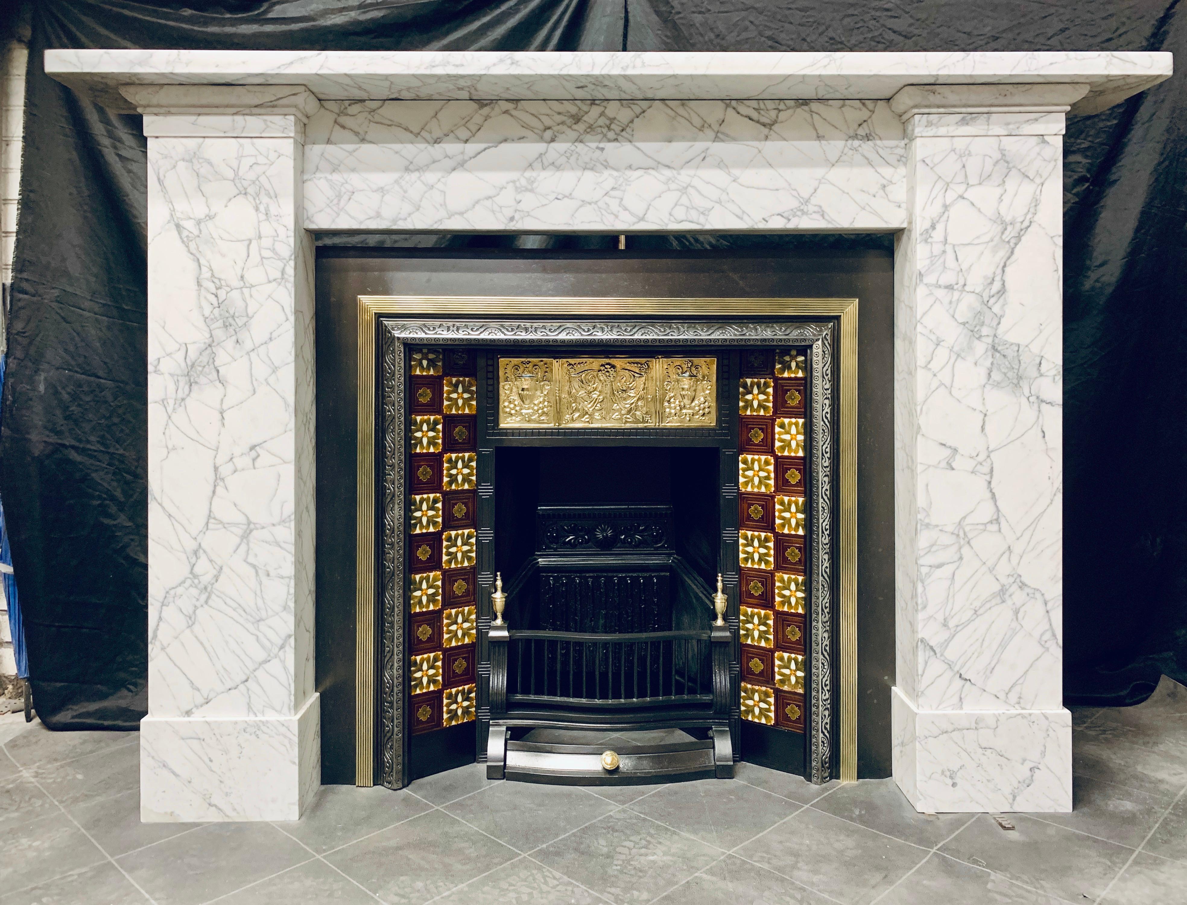 A large 19th century traditional Scottish pencil vein statuary marble fireplace surround, displaying beautiful veining and color formation-a generous and sturdy square shelf sits above an unadorned frieze, flanked by tall jambs displaying