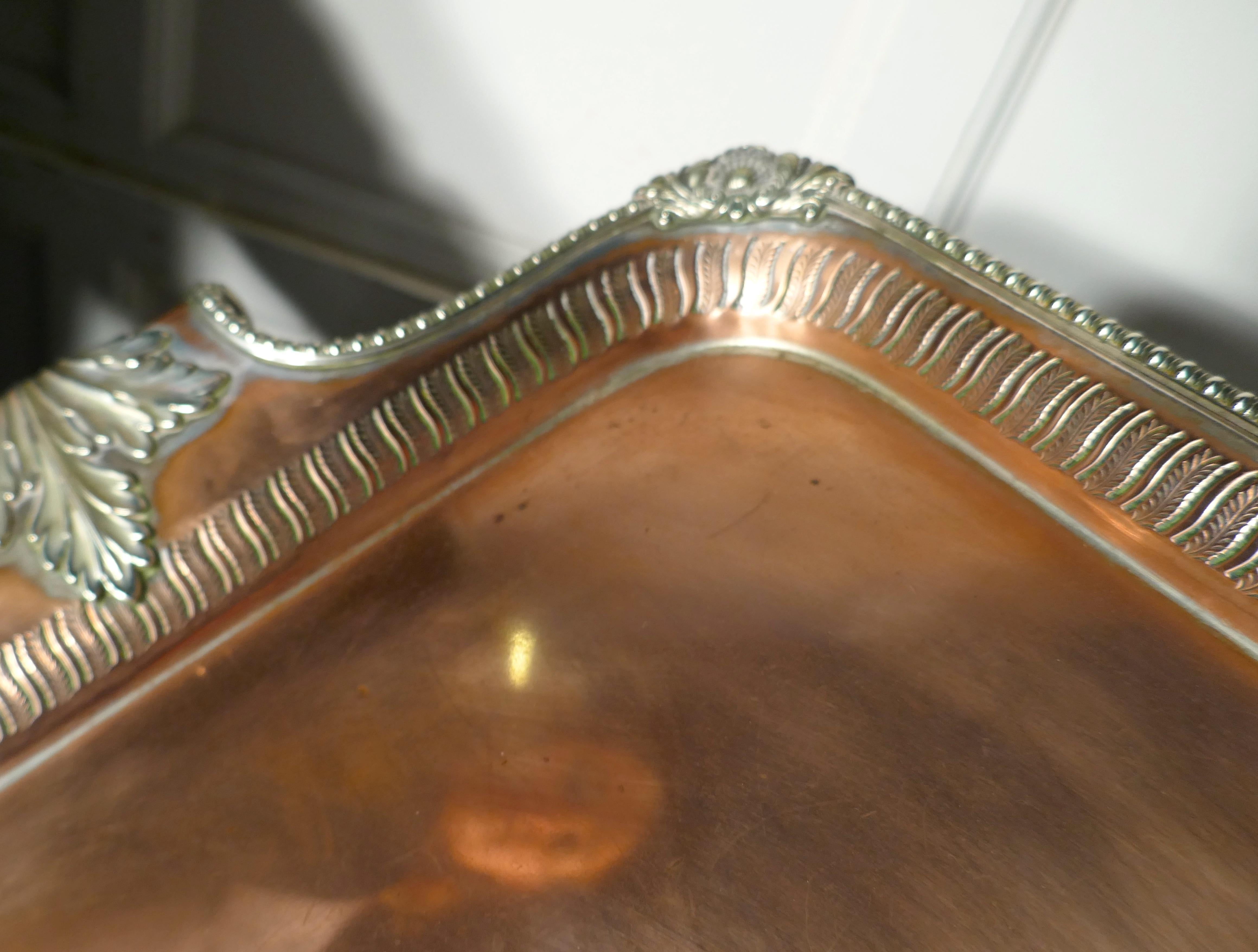 Large 19th century silver plated tray with pierced gallery

A lovey piece even more attractive as the silver plating has for away leaving the edging and the chased foliate handles in their original finish
The Tea is in good condition art from the