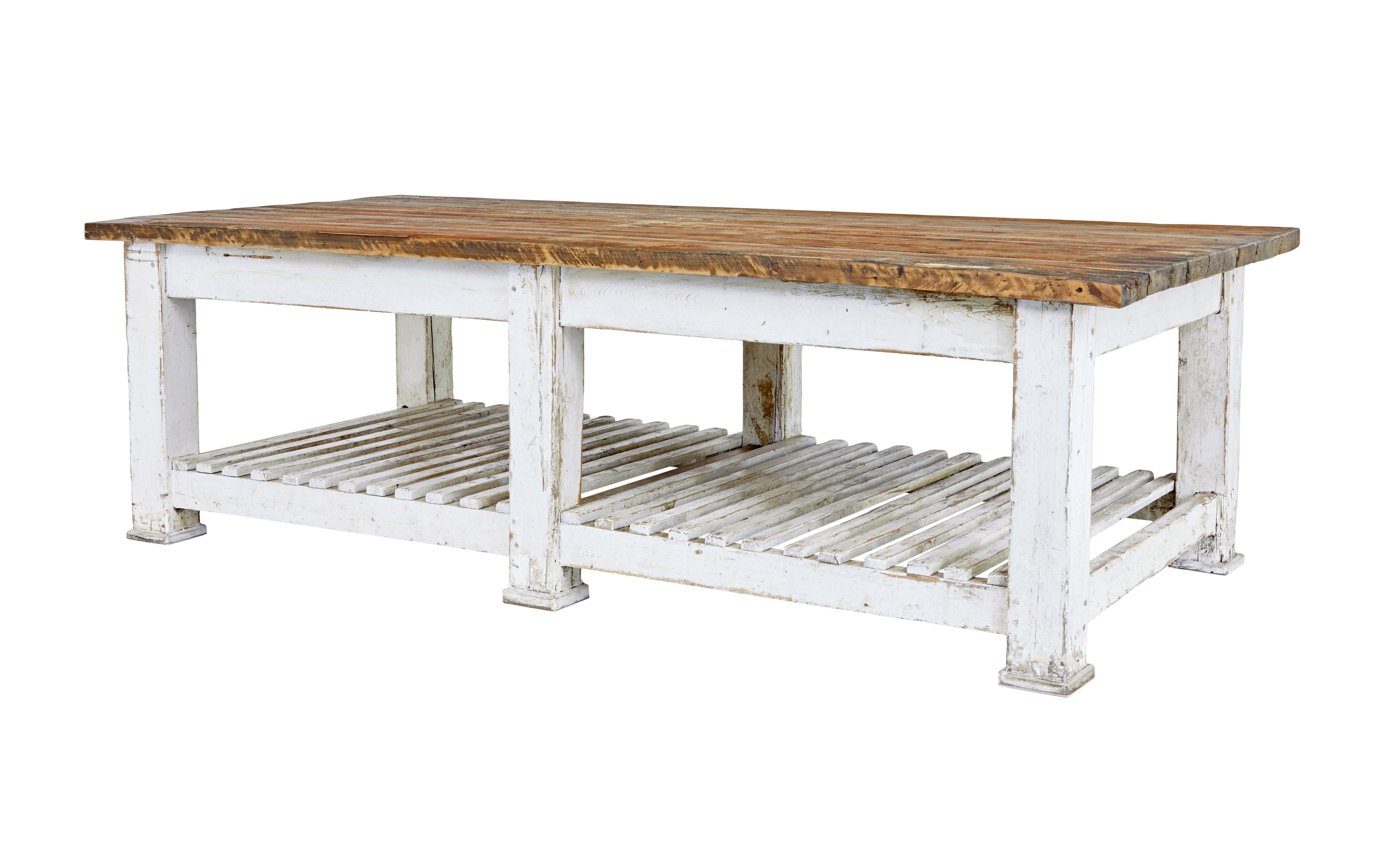Large 19th century solid pine work table circa 1890.

Impressive and large table which offers many possibilities for use.  Such as in the garden room, kitchen or the ideal solution for retail display.

Solid pine plank top which has been stained a
