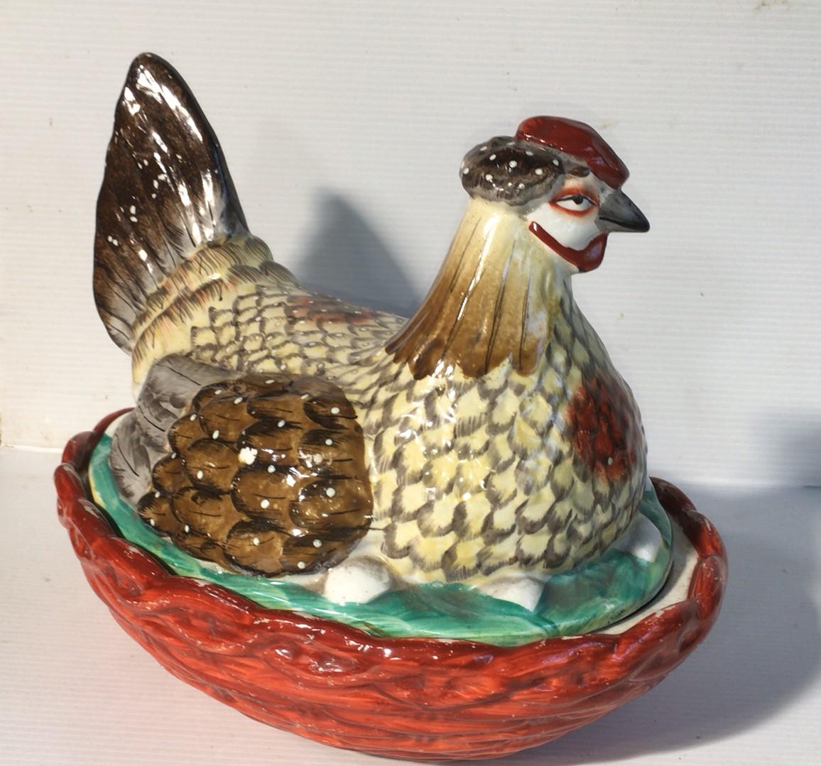 Colorful large 19th century Staffordshire hen on nest tureen with brown basket.
Measures: 10.5 inches Length.