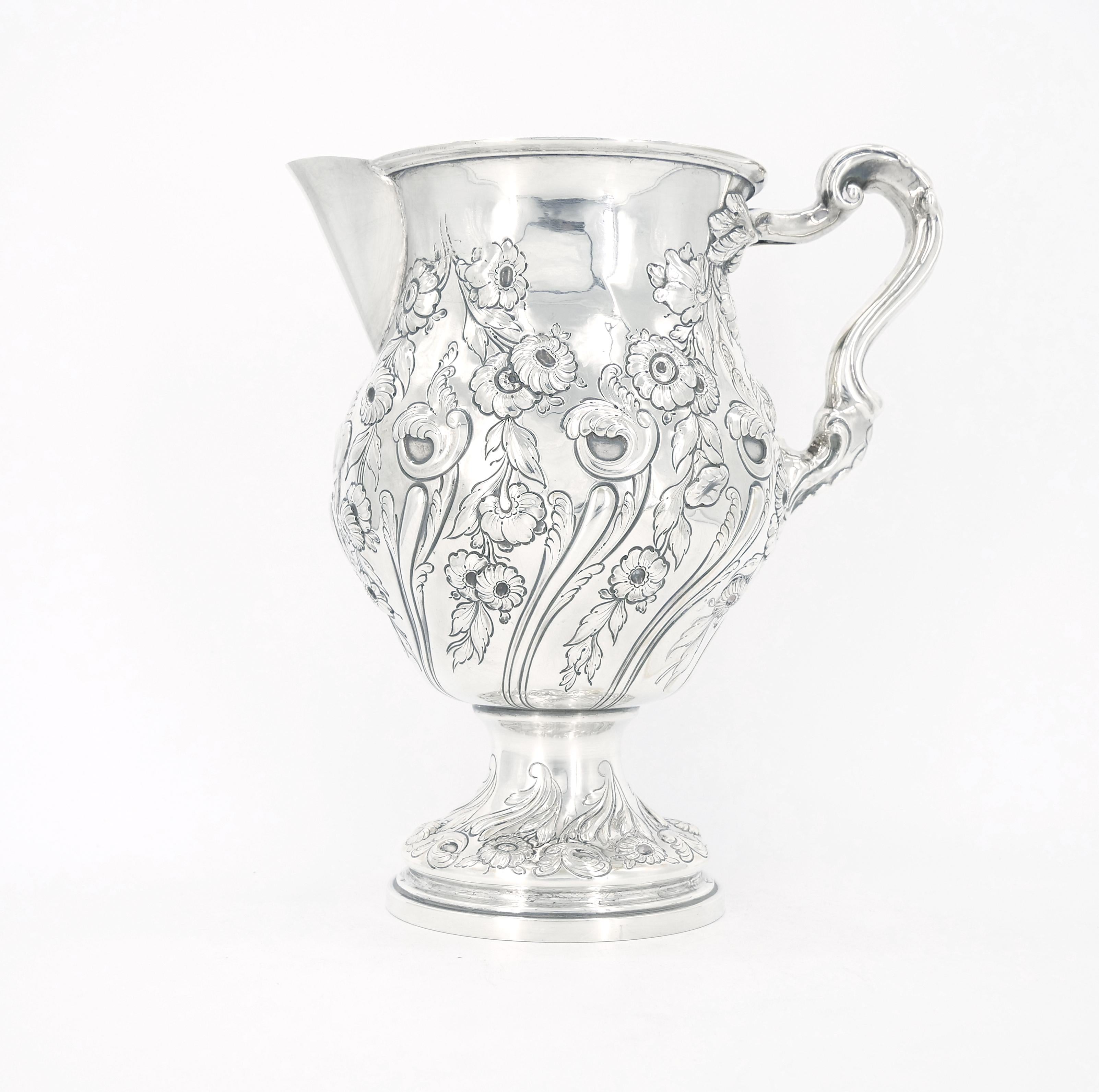 
Behold the resplendent beauty of this magnificent 19th century victorian style Black Starr Forest sterling silver tableware water pitcher. Immerse yourself in the opulent of a bygone era as you witness the exquisite craftsmanship and intricate
