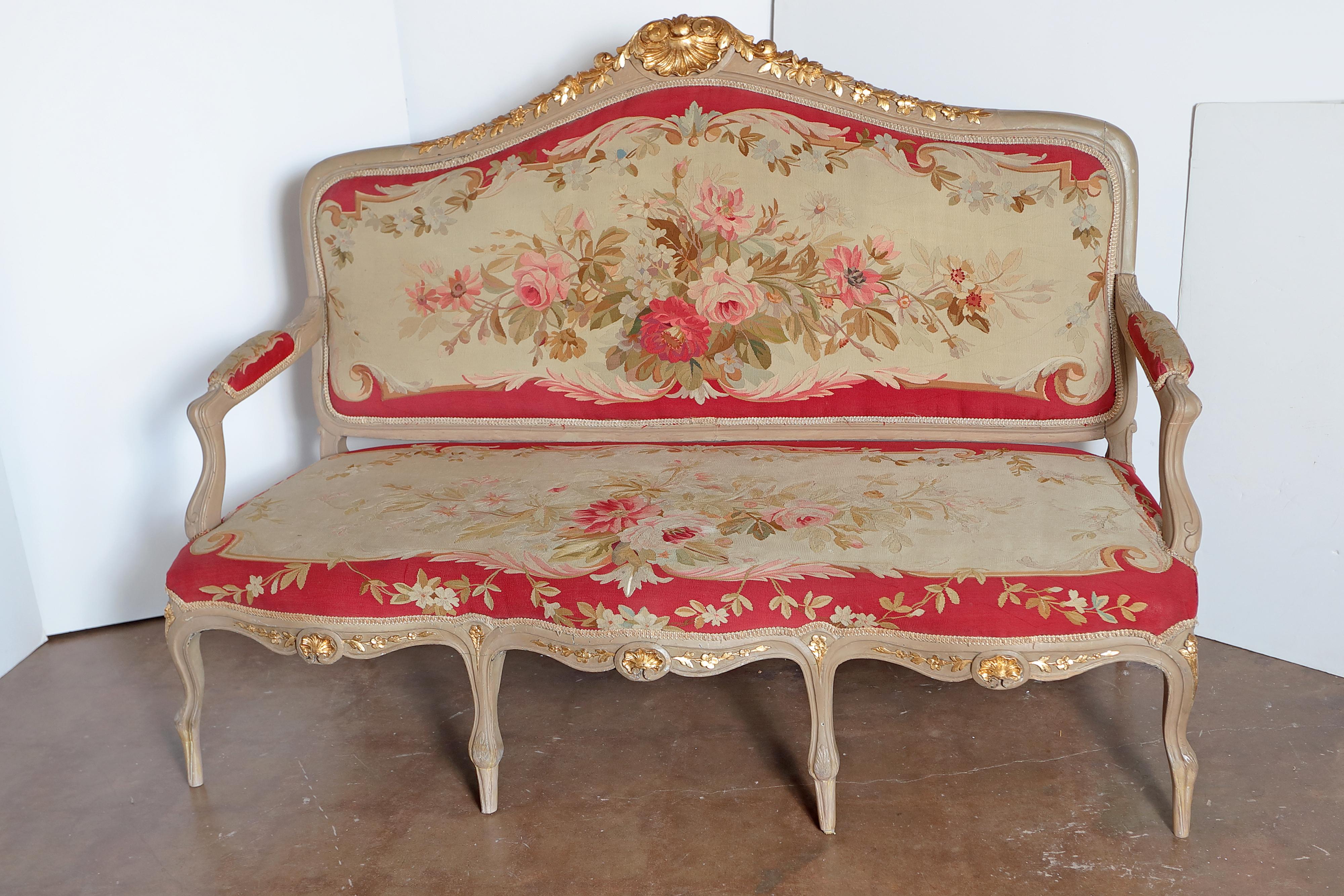 Beautiful 19th century French large suite consisting of a settee and 4 arm chairs and two side chairs. Original painted grey with parcel gilt details. Beautiful Aubusson tapestry with floral detail.