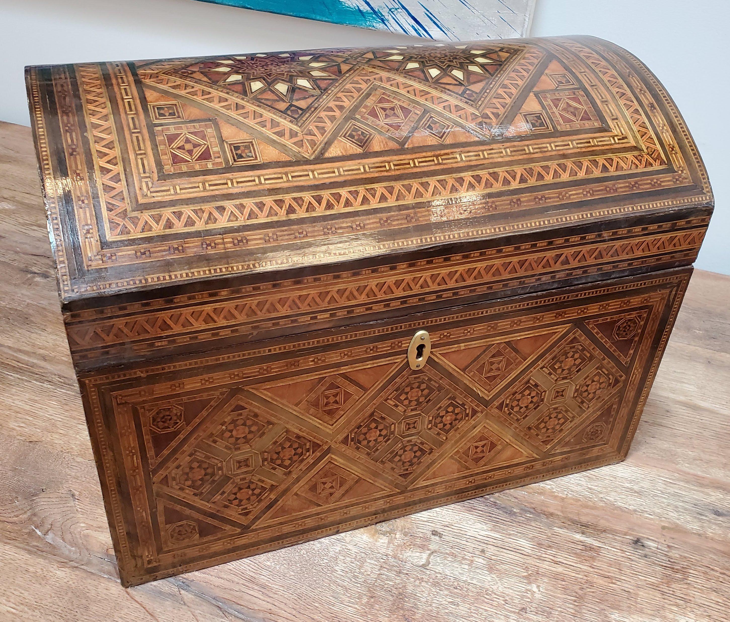 Large 19th century domed top inlaid box. Extraordinary geometric parquetry inlay. Various exotic woods and mother of pearl with velvet fitted interior. Damascus, circa 1890. 
Measures: 14” H, 19” W, 13” D.