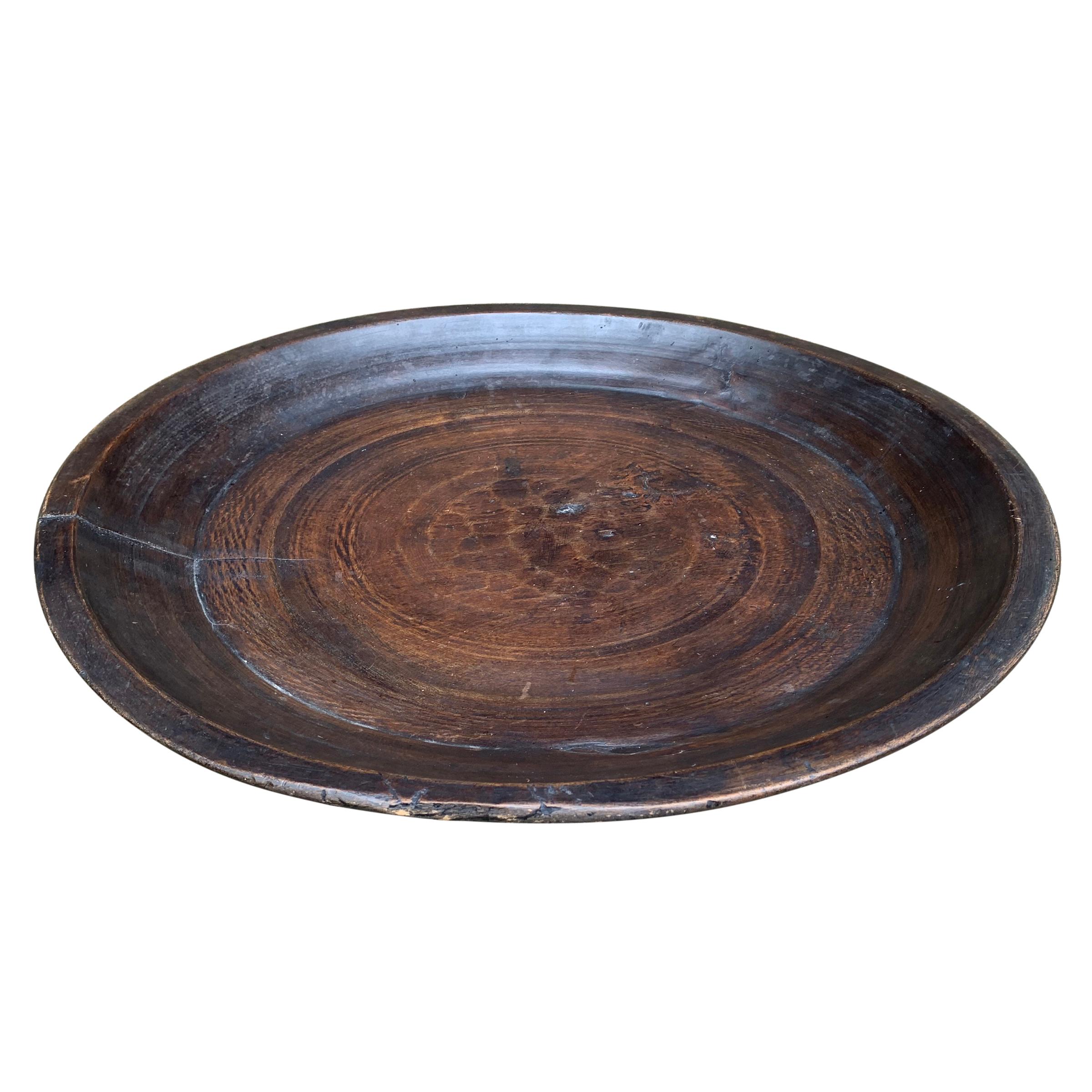 A wonderfully large 19th century turned wood tray with incised lines, a beautiful patina, and a smooth finish. The reverse side shows several additional incised lines from turning. Perfect for use as a catchall for mail, magazines, or any other