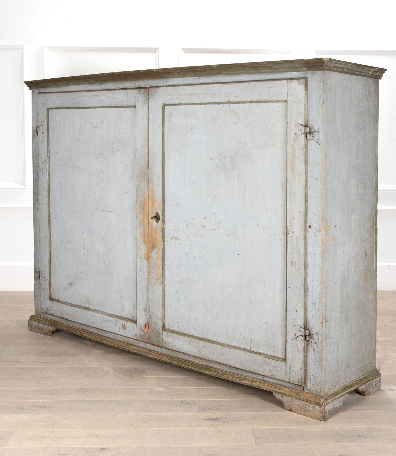 A rare early 19th Century two door Italian cupboard from a convent near Lucca.
Retaining much of its original paint, the cupboard has an unusual configuration of only two doors across its near two-and-a-half metre width!
The doors conceal an array