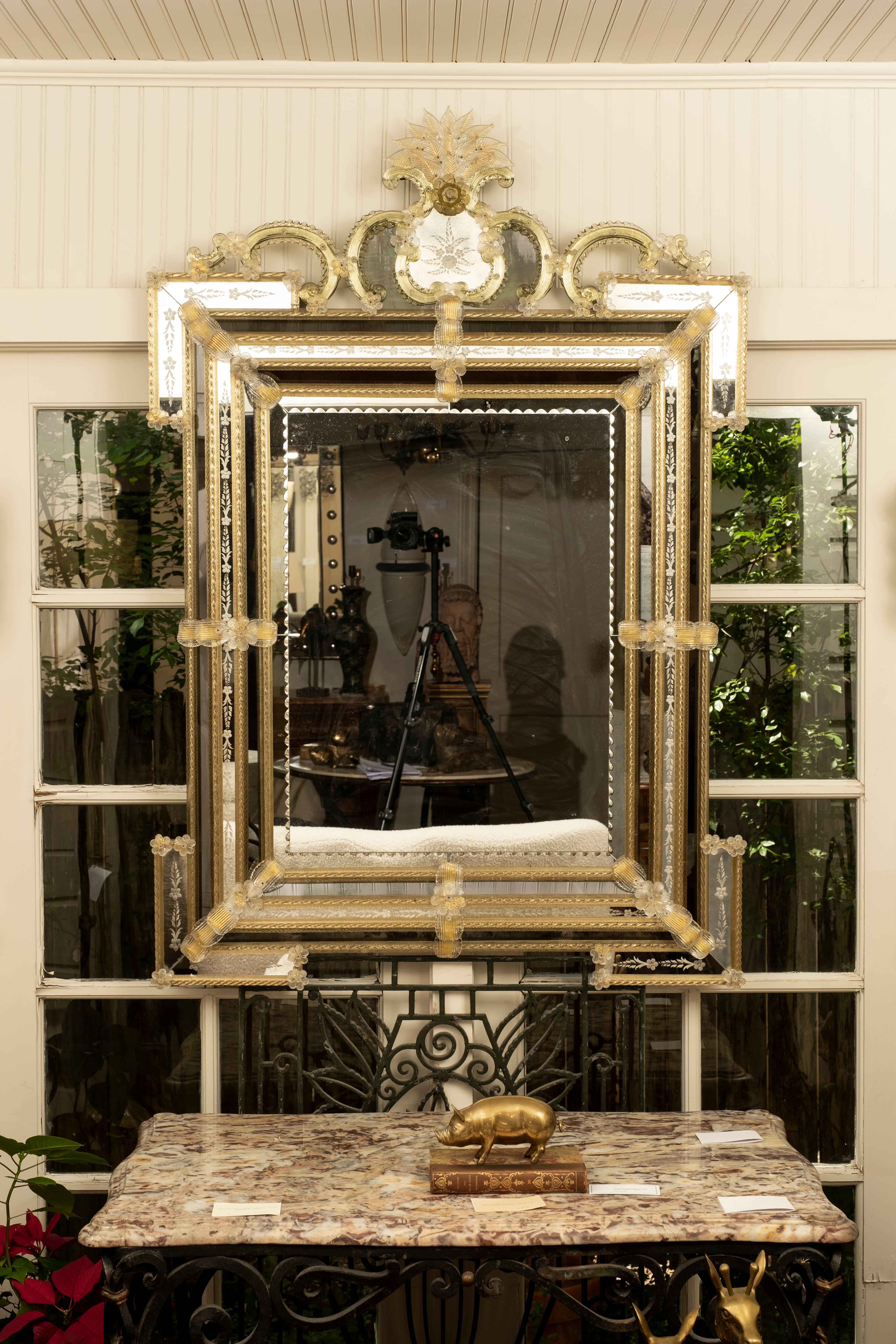 19th Century Venetian mirror-etched and beveled. This versatile antique venetian mirror is rectangular with beautiful etching, beveling including blown glass flowers and leaves. Stunning!.