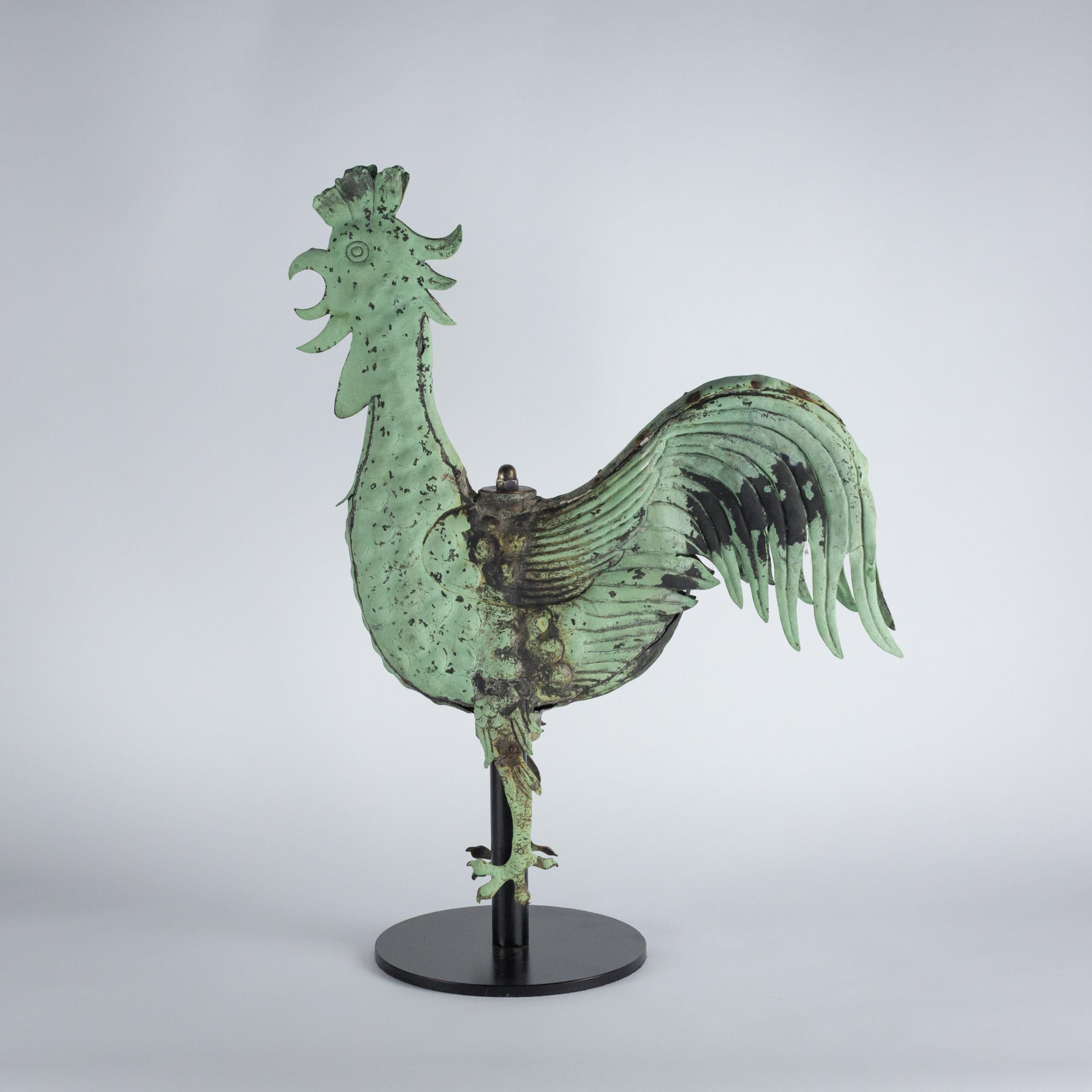 A Large natural verdigris full-bodied copper Cockerel weathervane is a fine and striking example of both Folk art and functionality. Traditionally used atop Churches, Barns and Homes to indicate wind direction. Crafted in copper this example