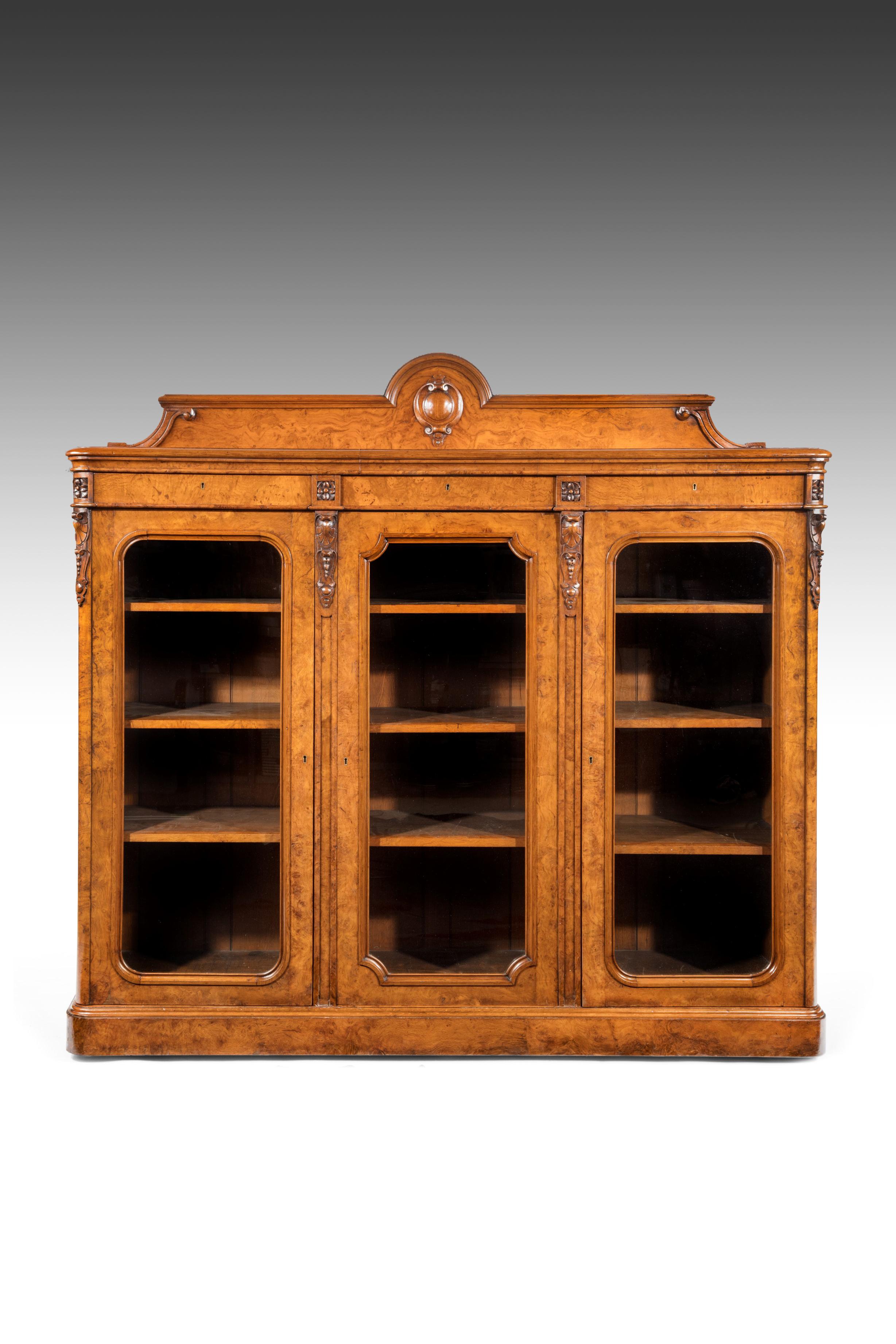 A quality 19th century Victorian pollard oak three-door bookcase of large proportions.

English, circa 1860.

The shaped gallery above a pollard oak veneered and mounded rectangular top containing three lockable frieze drawers separated by